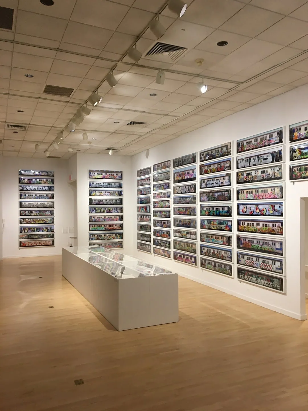 Walls covered in photos of graffiti-covered subway cars