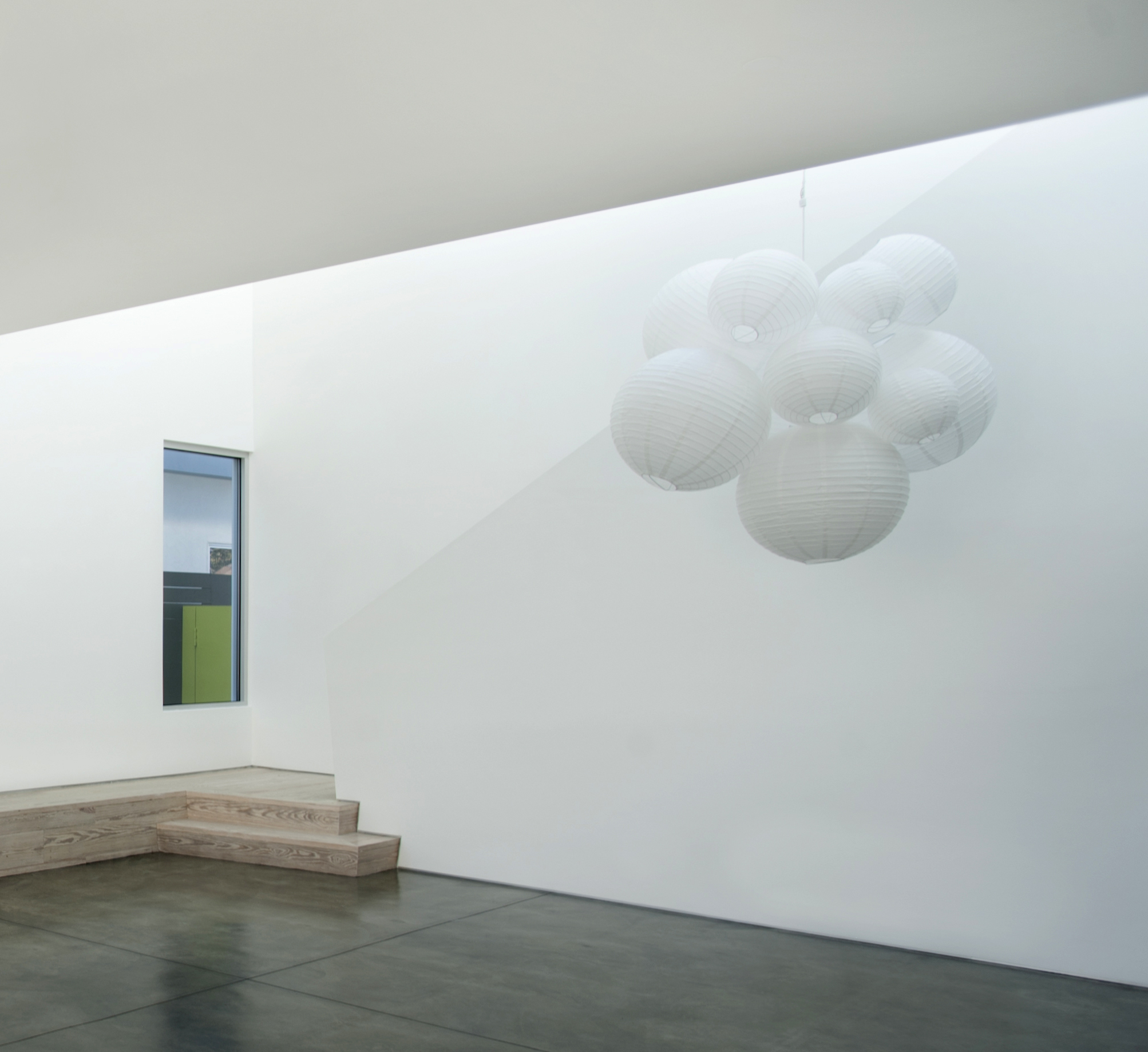 This custom paper lantern chandelier was personally made by Shana Cunningham for a spec house designed by Dennis Gibbens Architects . The finished fixture is like a sculpture; it looks different from every angle. Photo Credit: Dennis Gibbens Architects