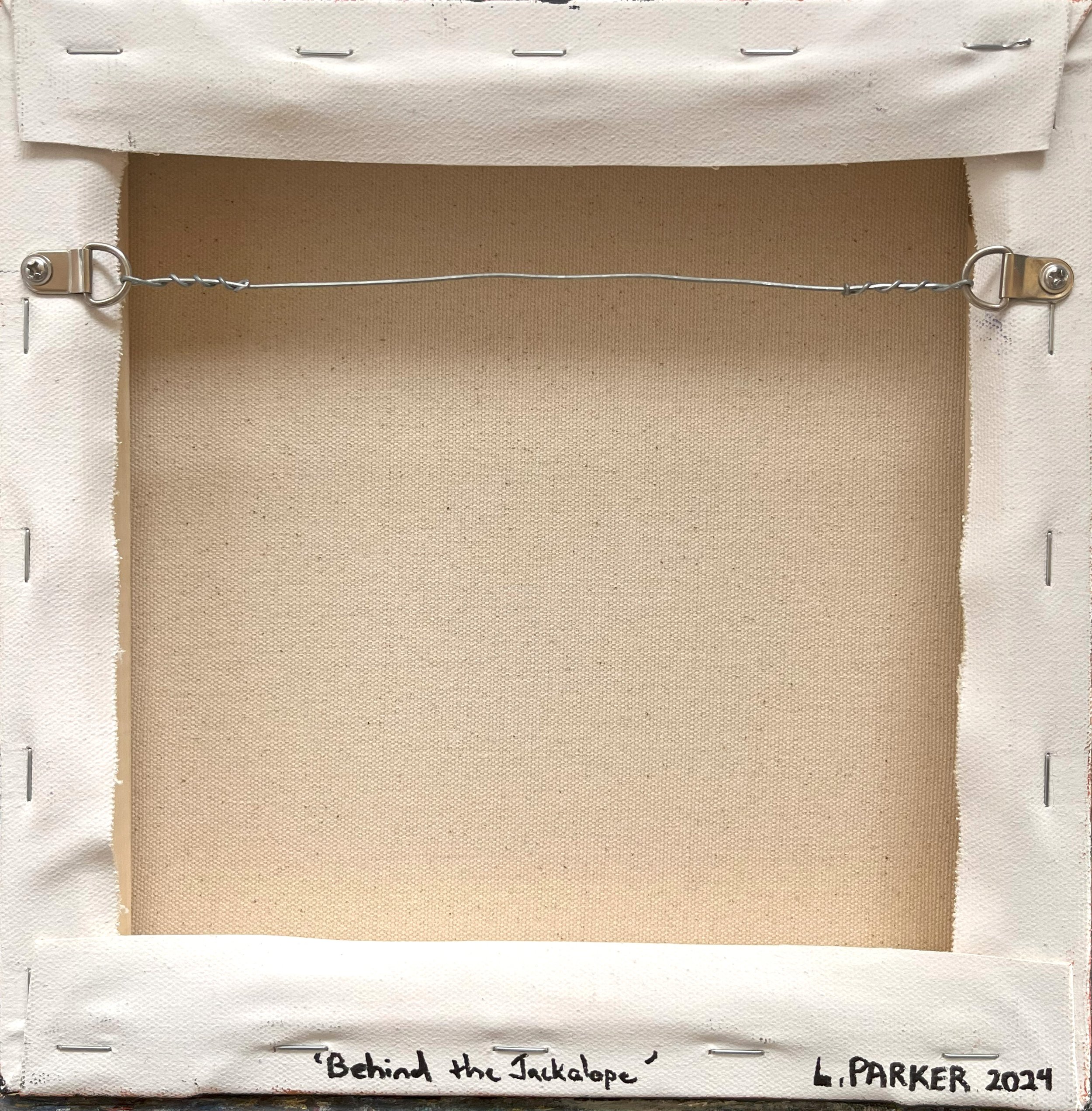 The back of Behind the Jackalope, showcasing the canvas ready to hang with secure wiring and painted edges for a polished, gallery-quality finish.