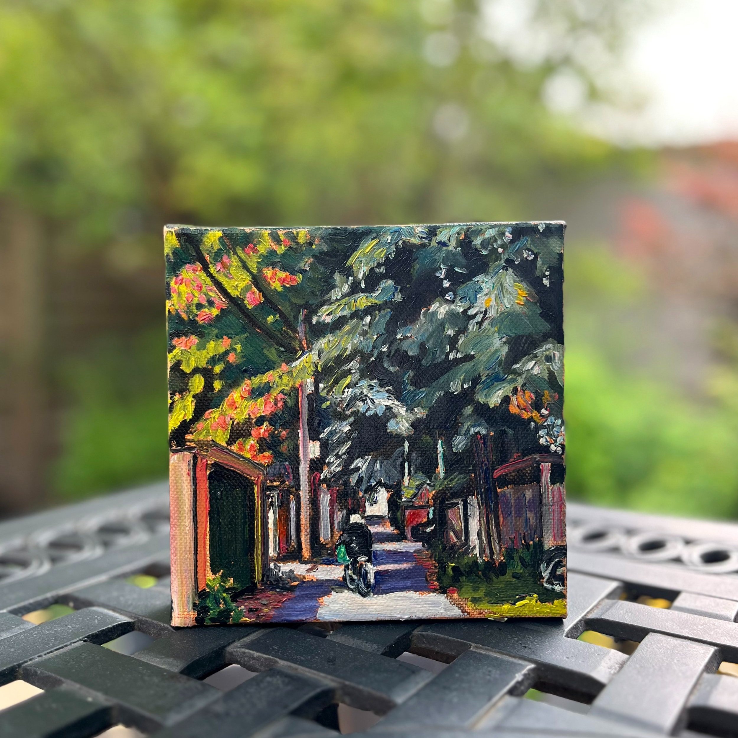 Outdoor view with oil painting 'Urban Commuter' showing the rich colours