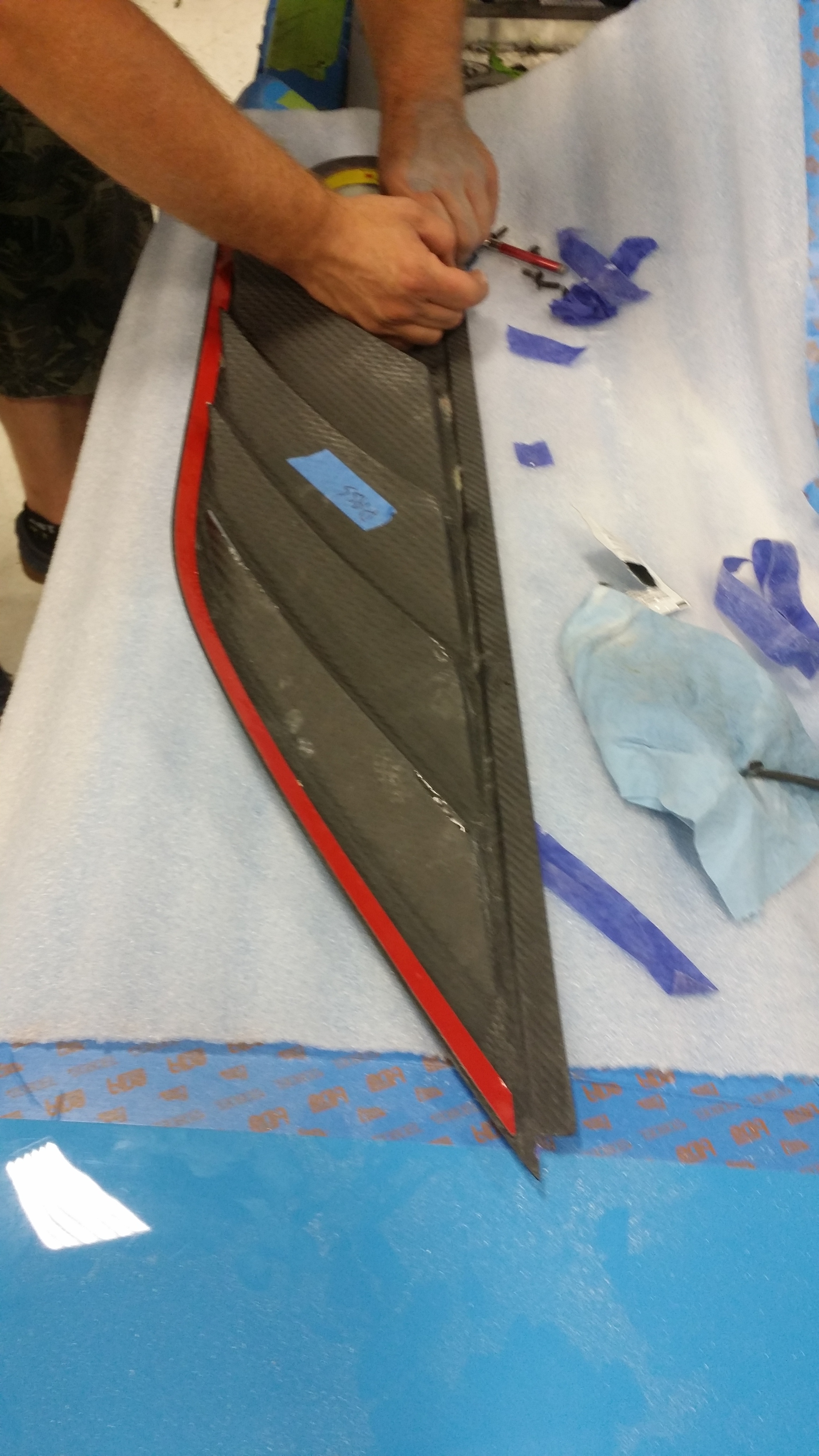 Installing double-stick tape on the back of the vent. Initially attaching the tape to the vent instead of the body flange ensures that the tape edges won't stick out and be visible.