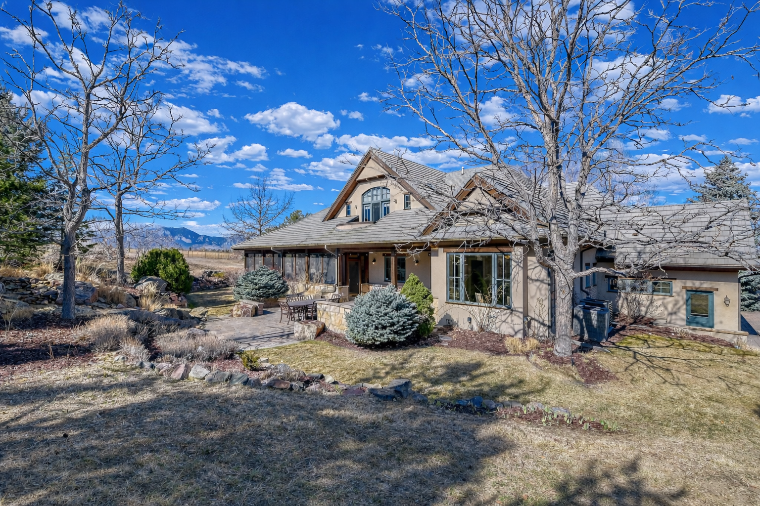 Rural house with mountain backdrop.png