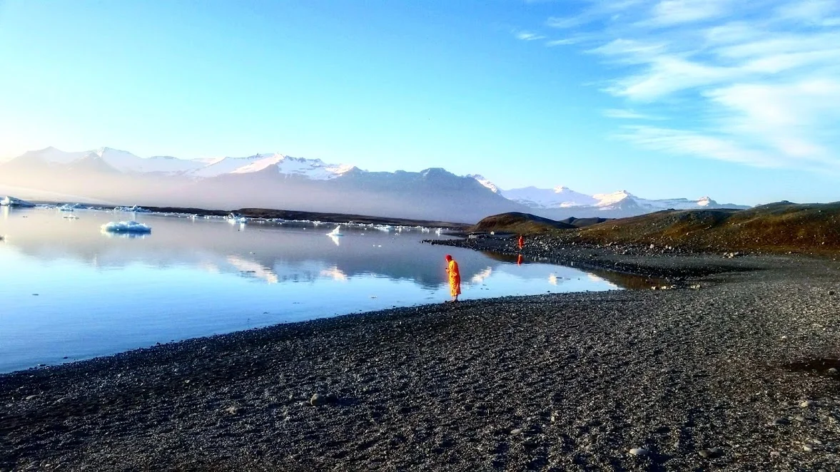 Buddhist monks mindfully gazing at a glacier in Iceland.