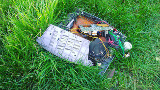 Copy machine waste in a field.