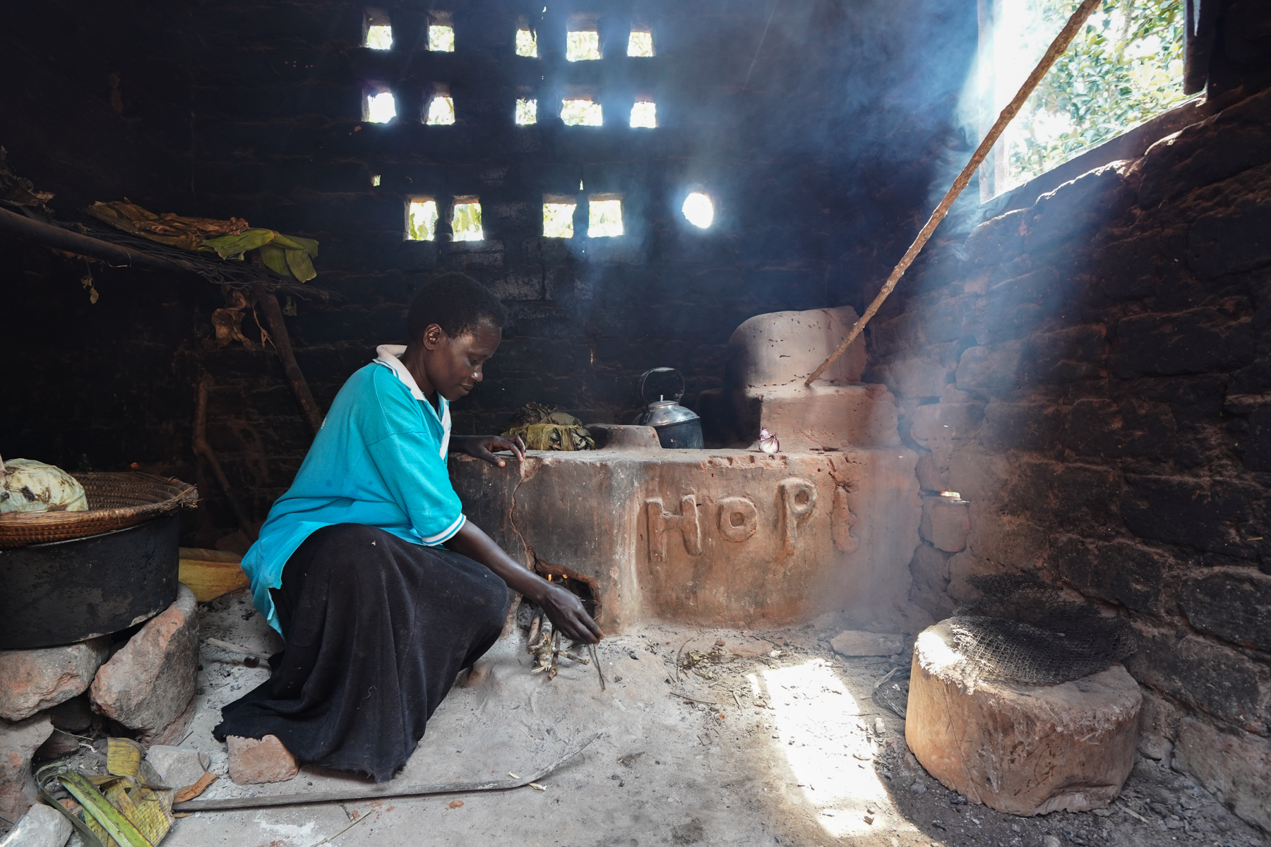 An example of the energy-efficient cookstove being built by women in the HoPE-LVB project. While traditional cookstoves make cooking areas quite smoky, this cookstove has a chimney that filters smoke outside. With more insulation for the fire, it also conserves firewood use.