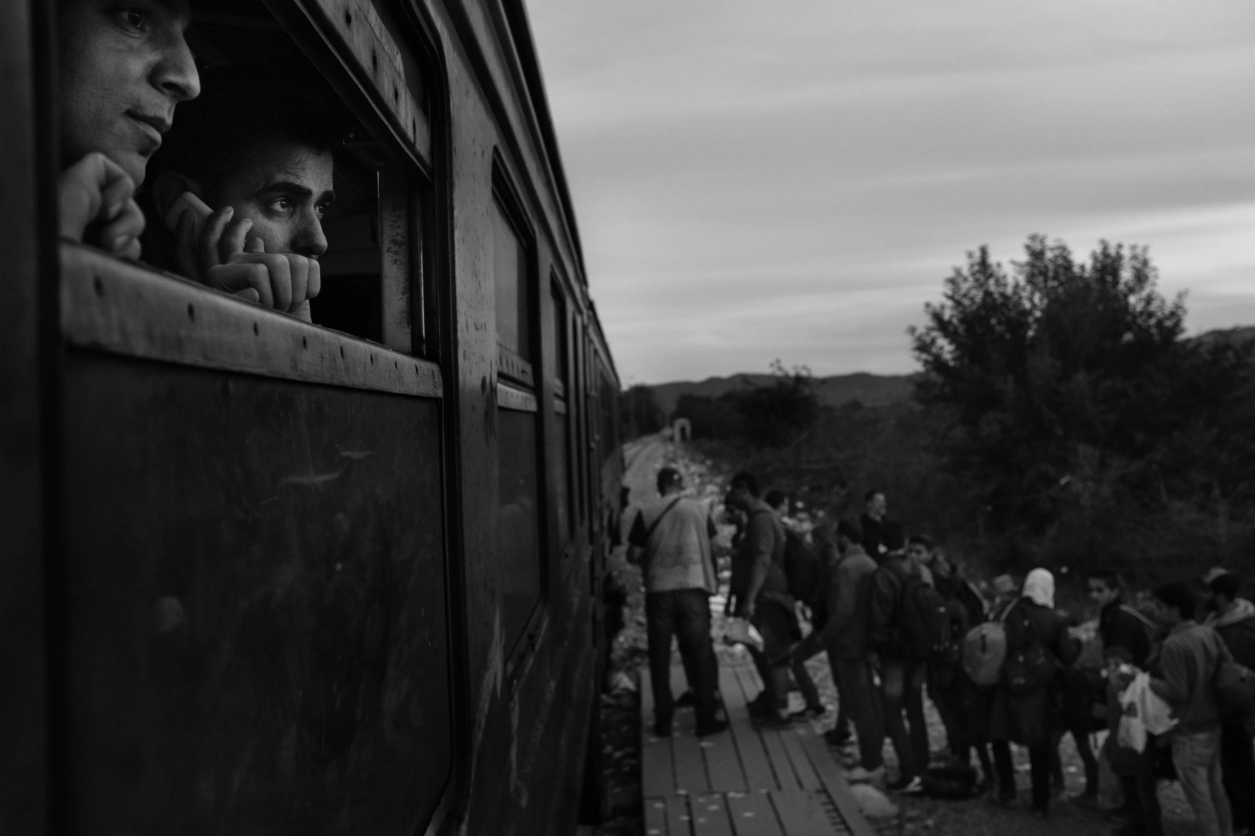  Rwand Ali, from Syria, watches refugees board a train to the Serbian border. 