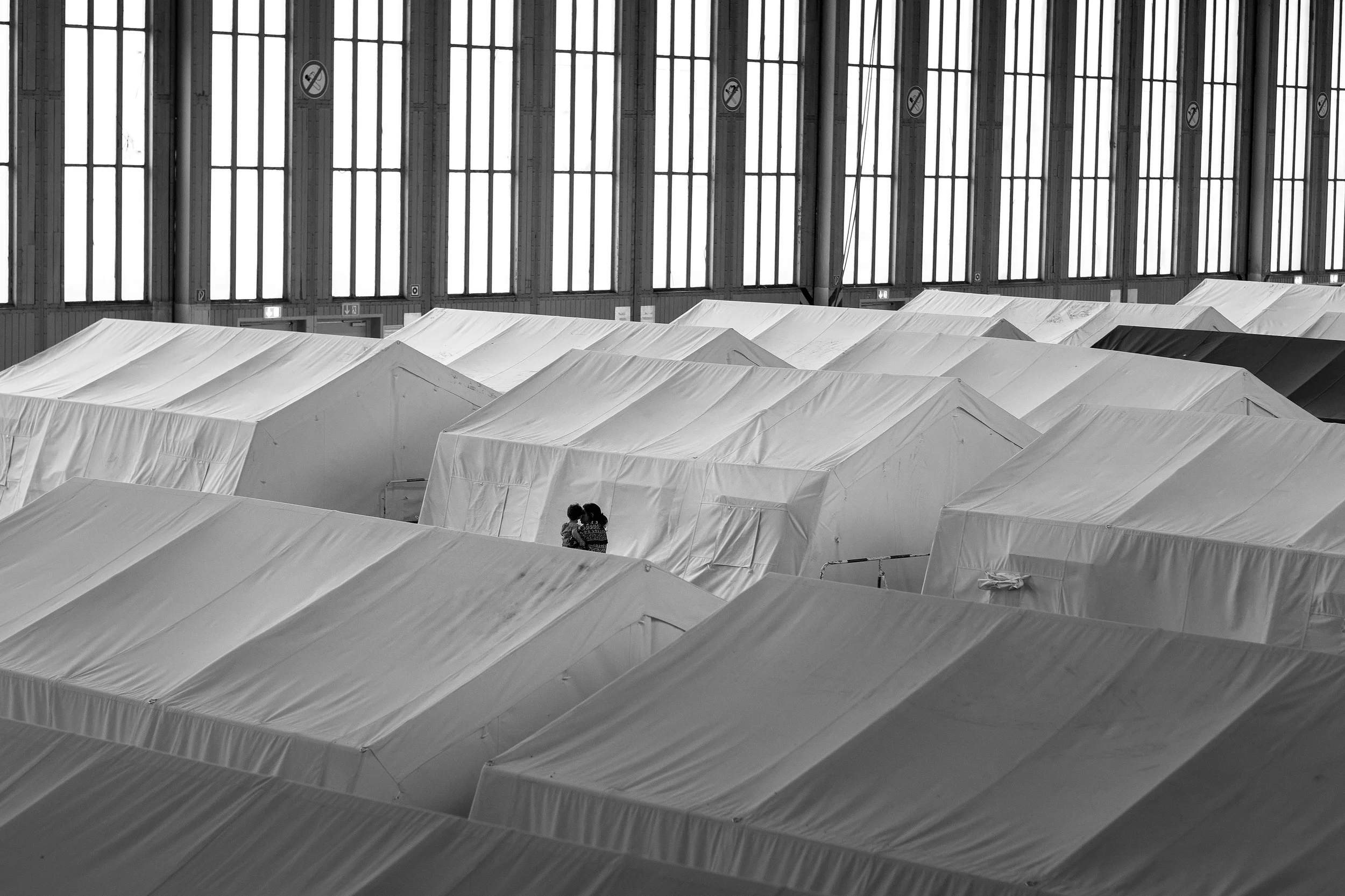  A mother and child in a refugee camp that houses 2,300 people in a former airport hanger in Berlin. 