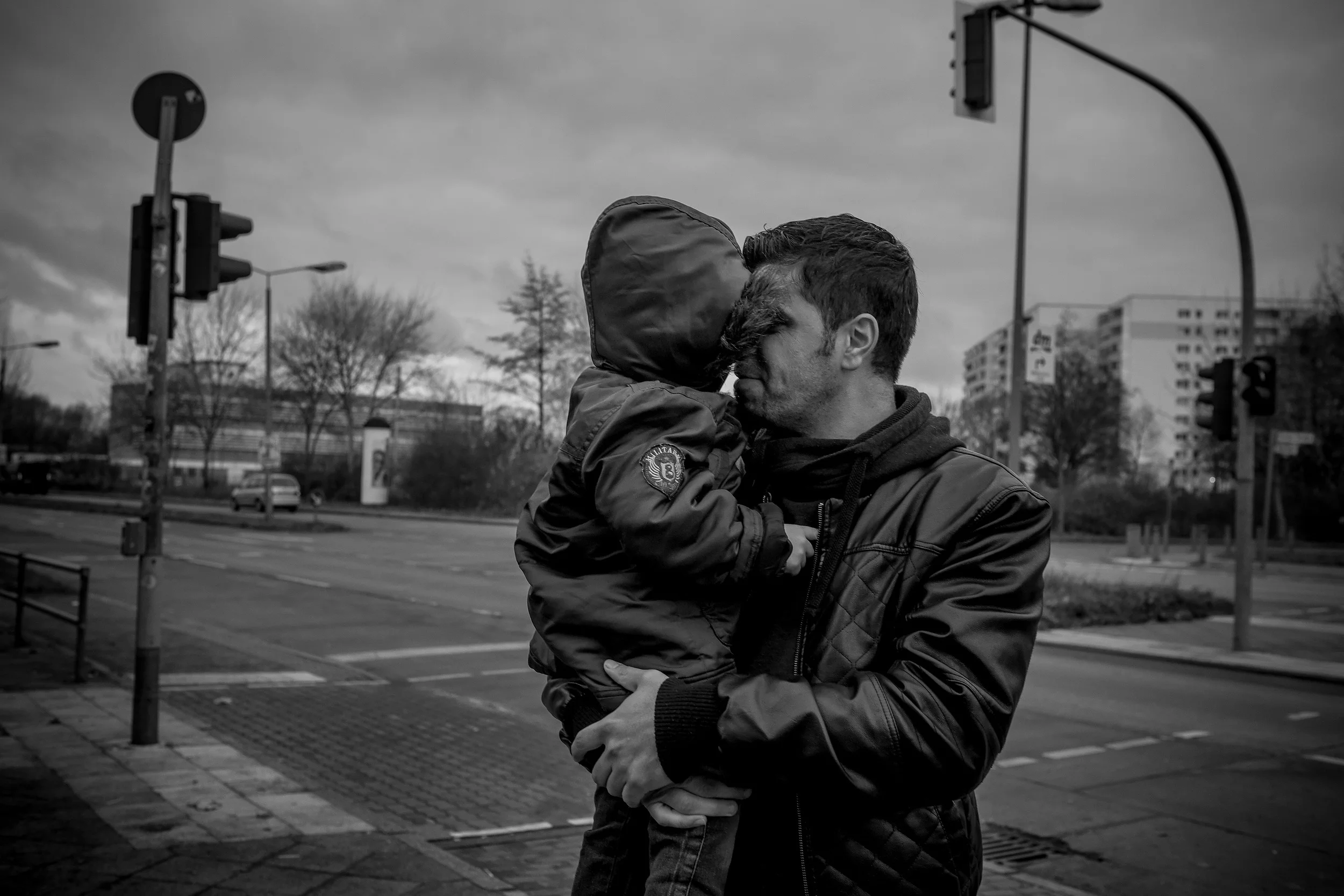  The Raslan family, refugees from the destroyed city of Homs, Syria, hold one another at an emergency shelter in Berlin, Germany. 