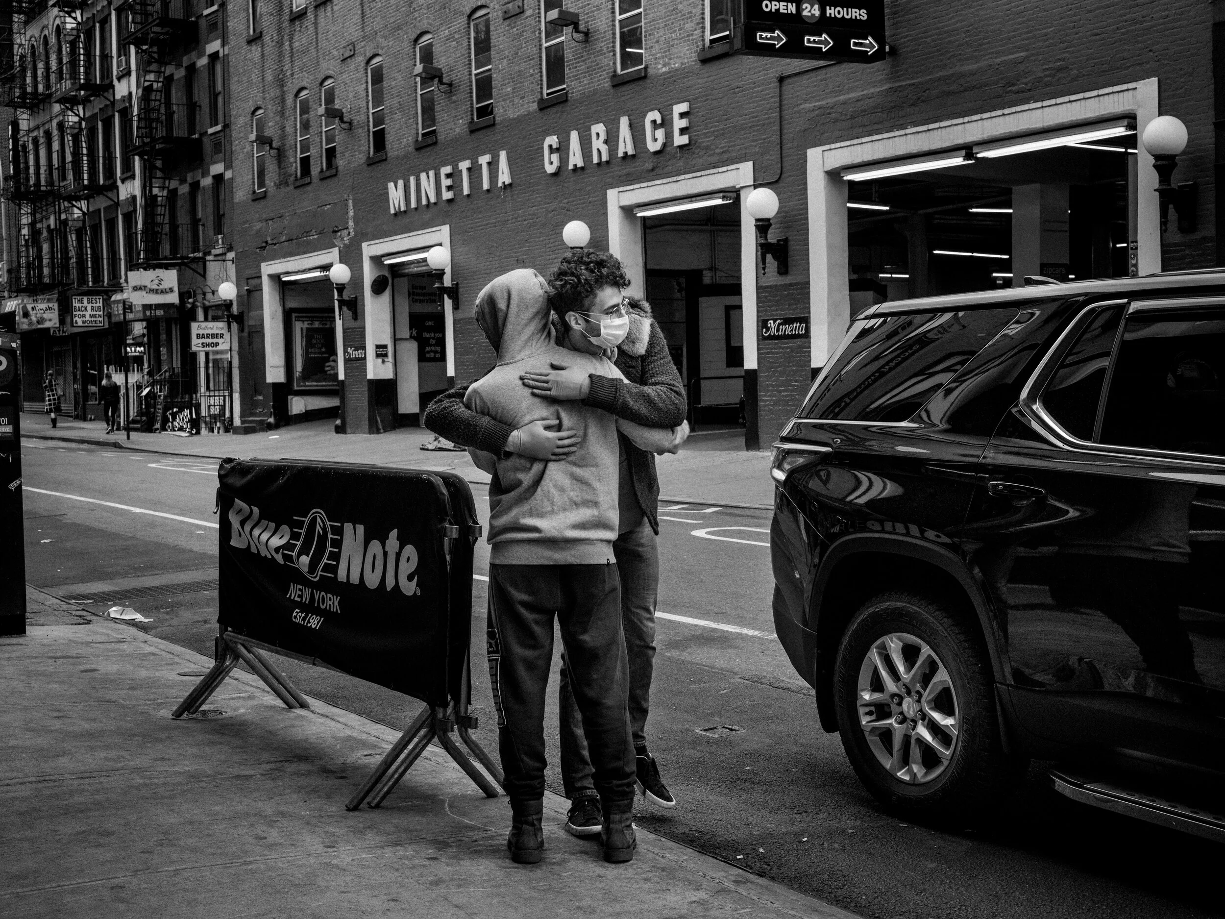  Masked and gloved, friends embraced in Greenwich Village. 