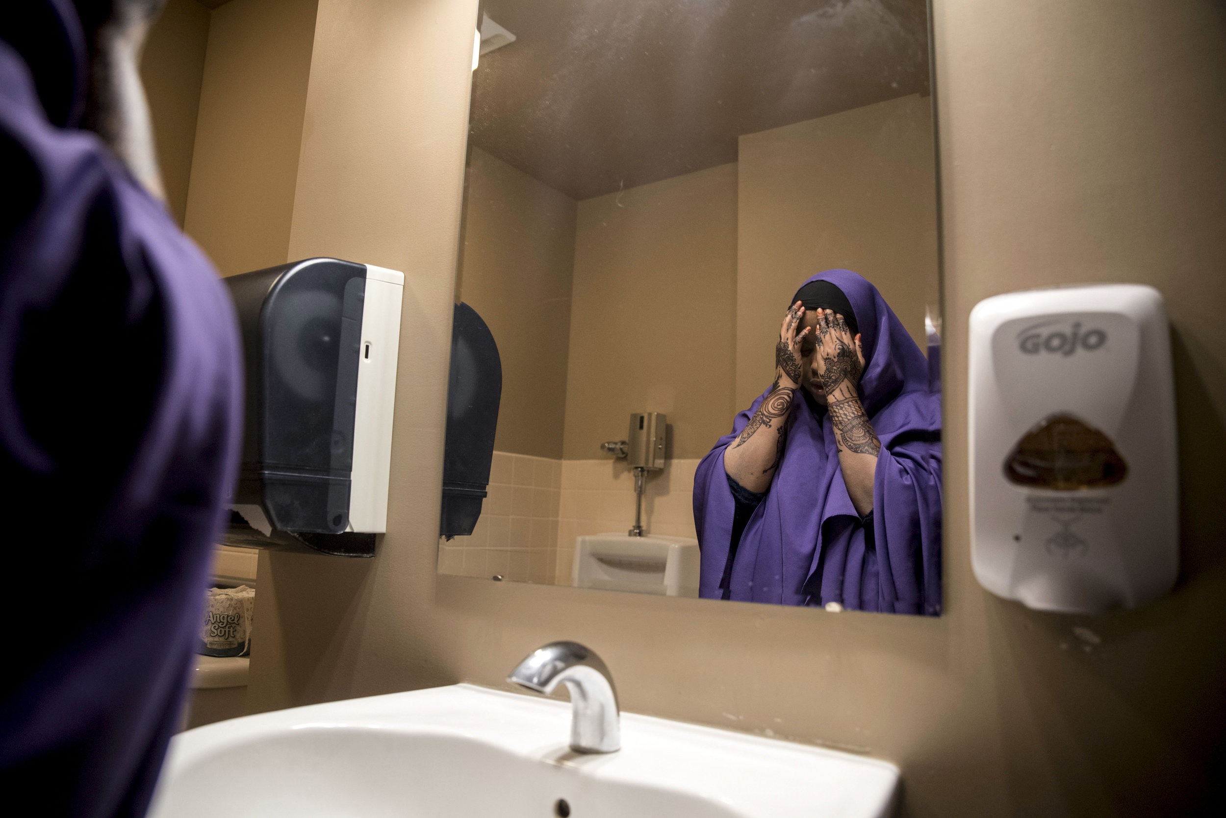  Kosar washes her face in the bathroom before praying during her lunch break at United Community Action Partnership Feb. 13, 2018 in Willmar. After graduating high school, she worked several jobs and now works as a Somali Bilingual Outreach Worker at