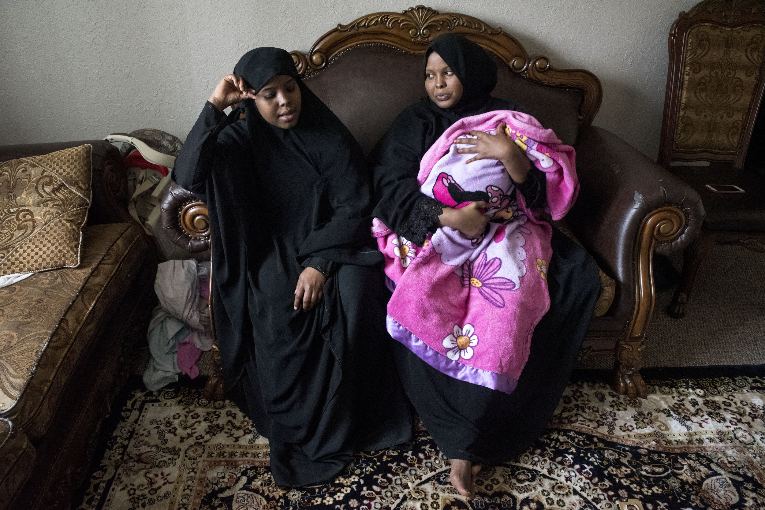  Kosar, left, and her sister Ismahan Kosar with her three-month-old son Ilhan Liban sit on the couch in their apartment in Willmar Mar. 30, 2018. Kosar’s sister gave birth to Liban this January. Both sisters stayed in Minnesota while their family liv