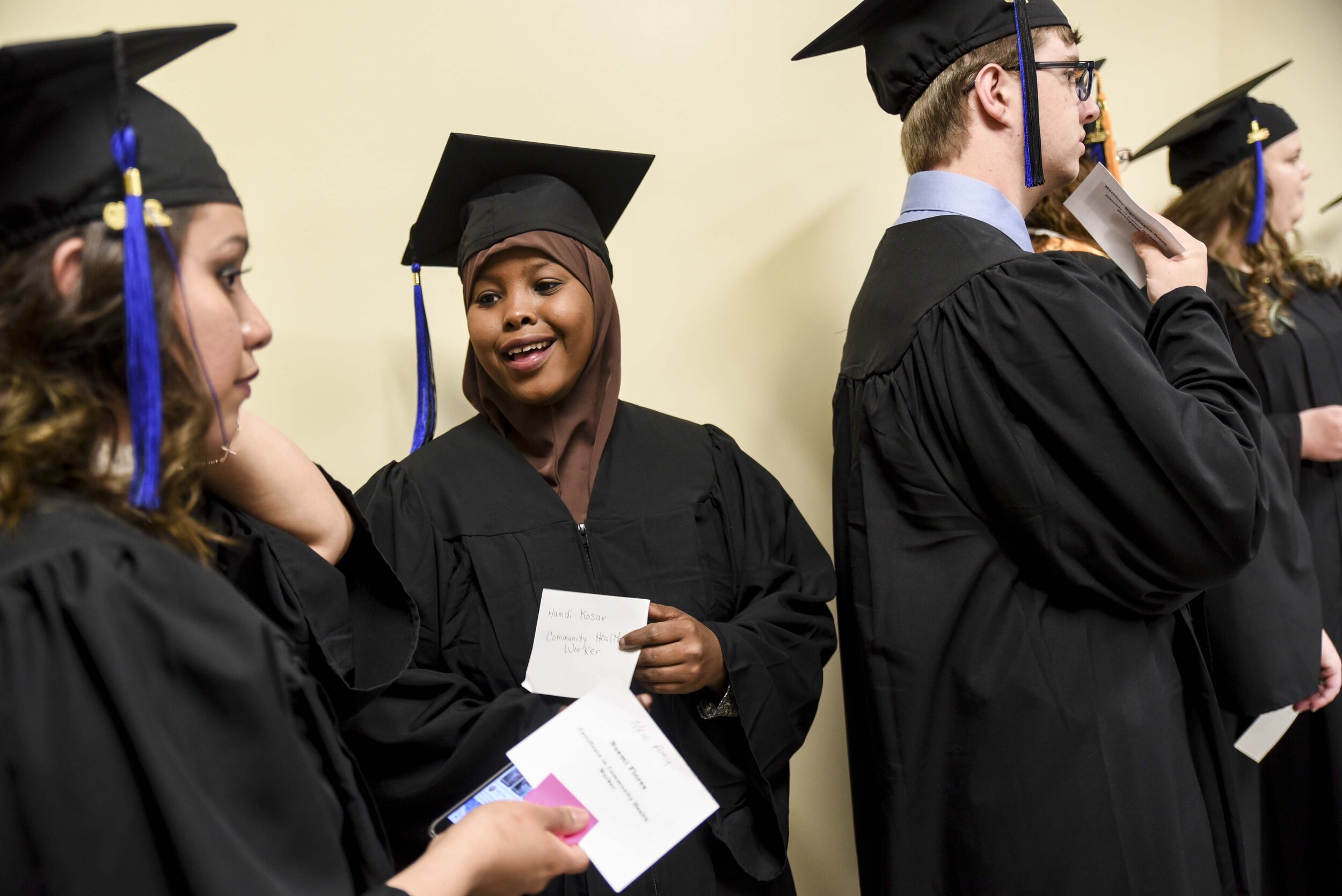  Hamdi Kosar chats with a friend before the Minnesota West Community and Technical College graduation ceremony May 15, 2019 at Yellow Medicine East High School in Granite Falls. Kosar graduated with a certificate in being a Community Health Worker. 