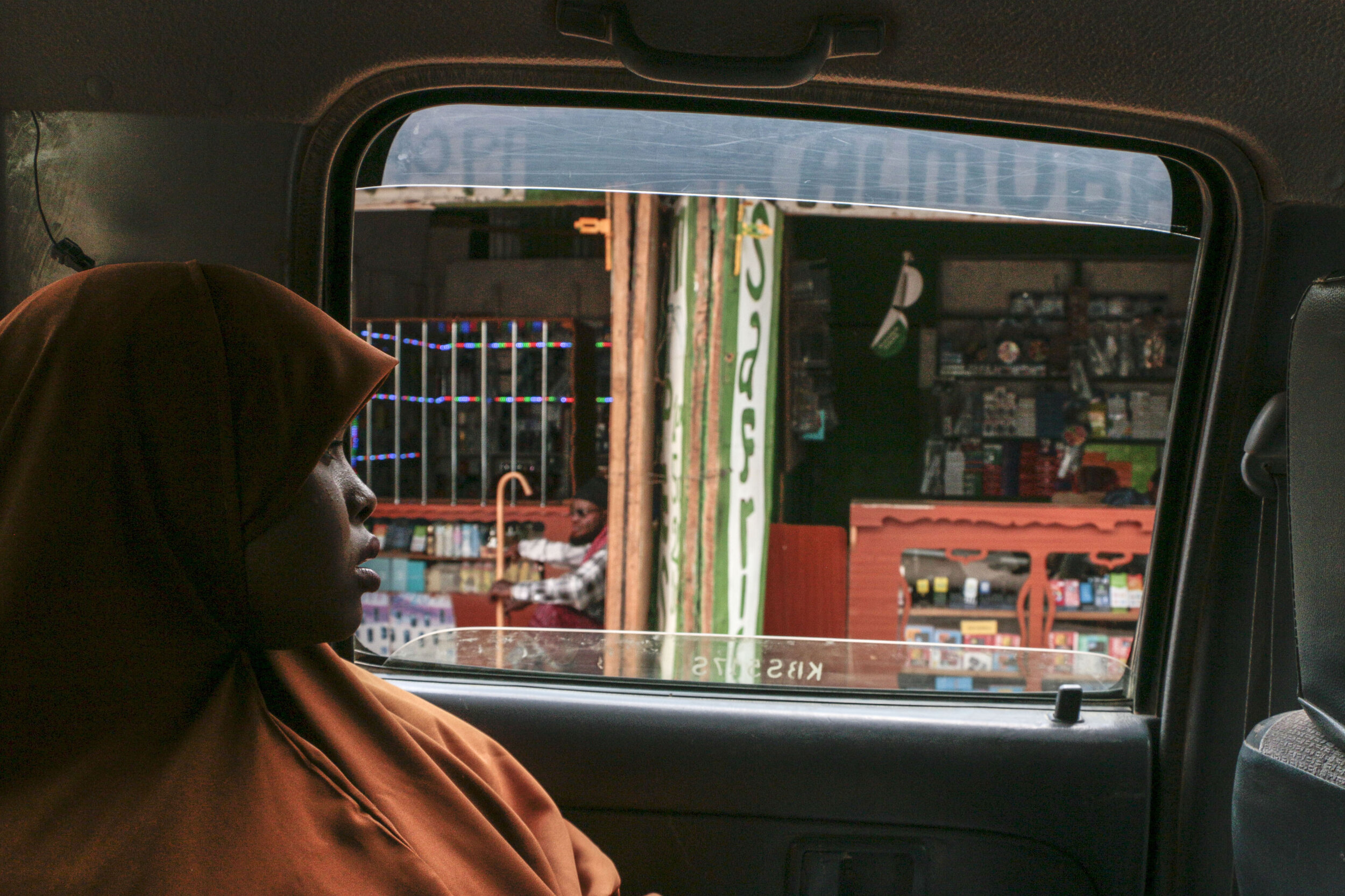  Hamdi Kosar looks out the window while driving through the marketplace Aug. 20 at the Dagahaley Refugee Camp in Dadaab, Kenya. Many refugees have their own business and sell goods at the market place within the camp. “It brings back memories,” Kosar