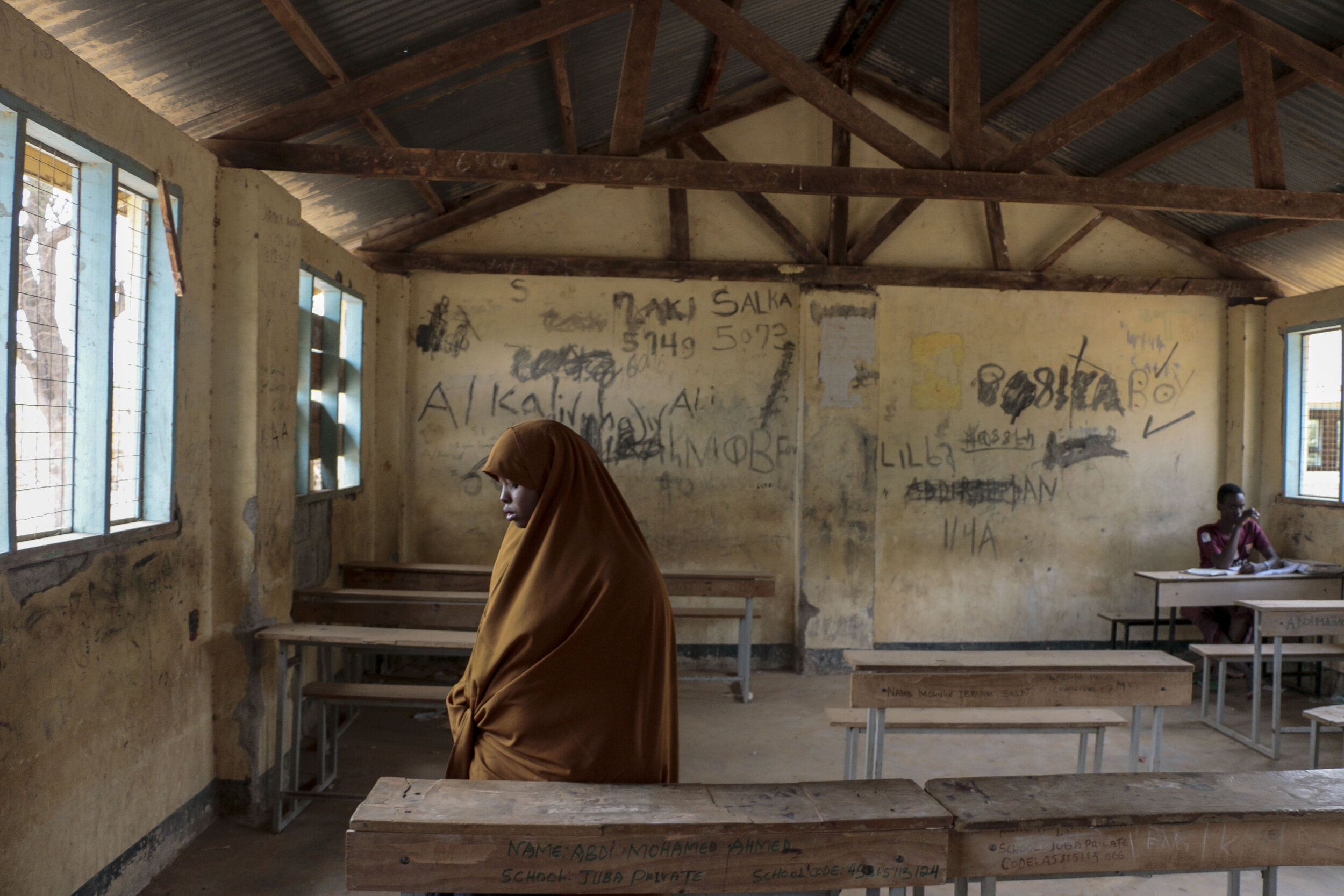  Hamdi Kosar stands up after sitting at a desk in her former elementary school, Juba Primary School, Aug. 20, 2019 at the Dagahaley Refugee Camp in Dadaab, Kenya. The school offers many forms of enrichment, including the debate team which she was a p