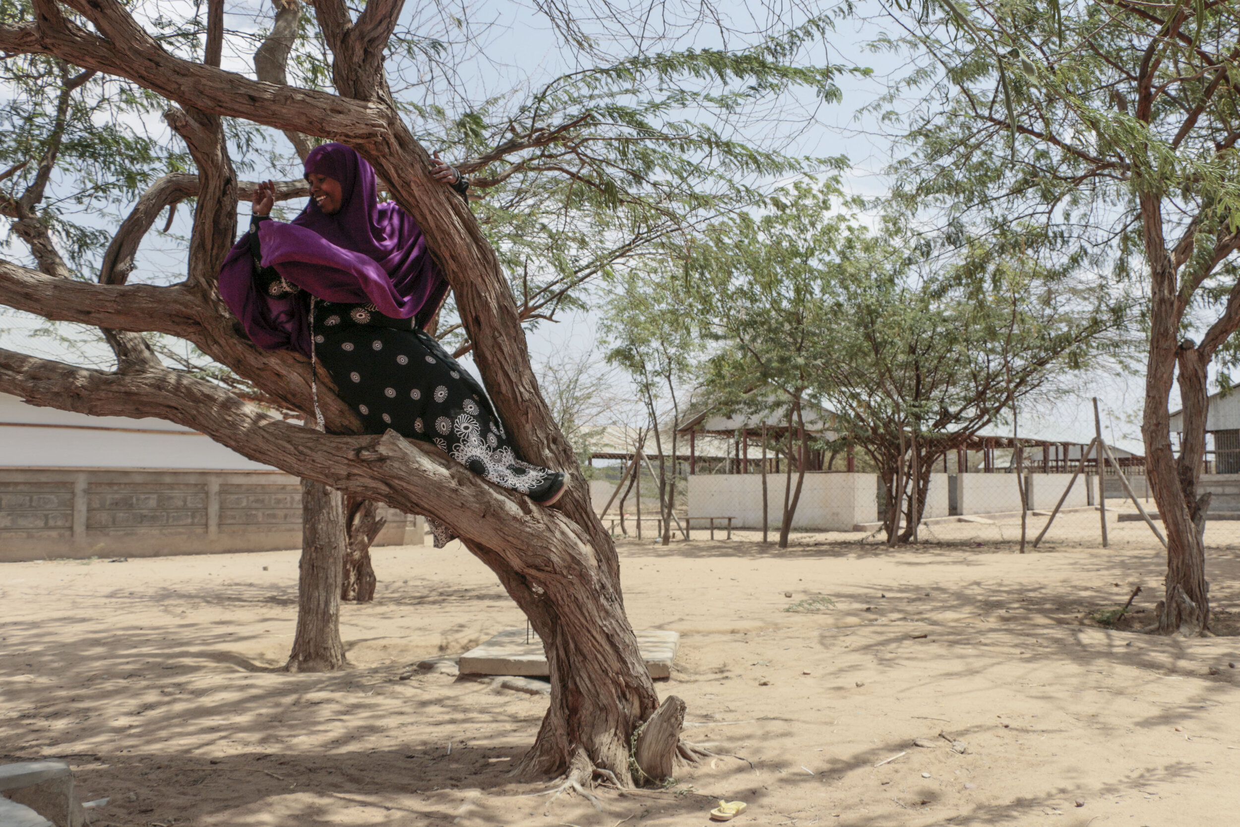 Hamdi Kosar climbs a tree “just like I used to do” Aug. 19 at the Dagahaley Refugee Camp in Dadaab, Kenya. 