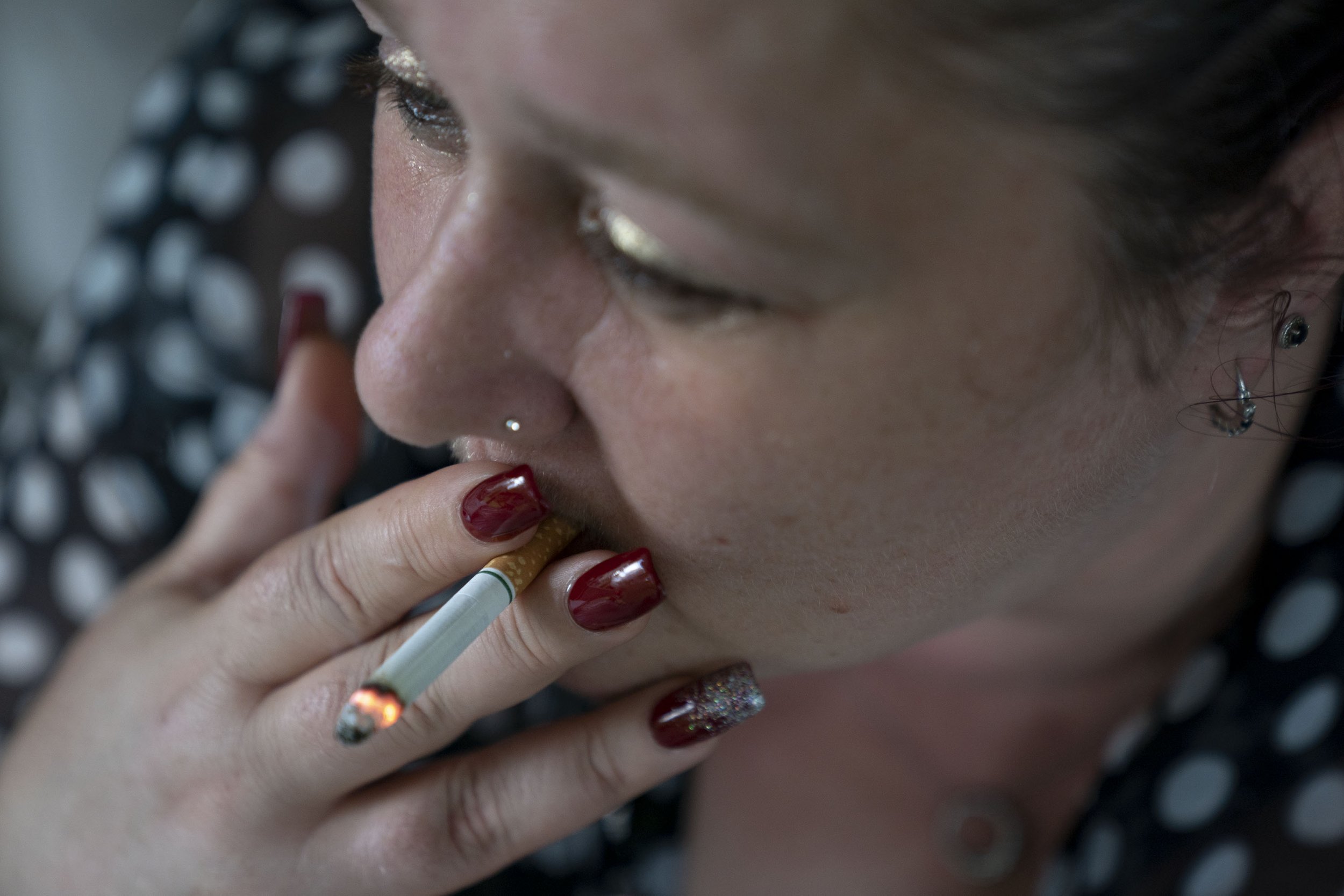 Resident DeOnza Carter, 44, originally of Columbus, Ohio, smokes a cigarette outside of the Serenity Grove house on Oct. 15, 2021 in Athens, Ohio. Carter says that smoking cigarettes helps her occasionally calm down to cope with her multiple mental