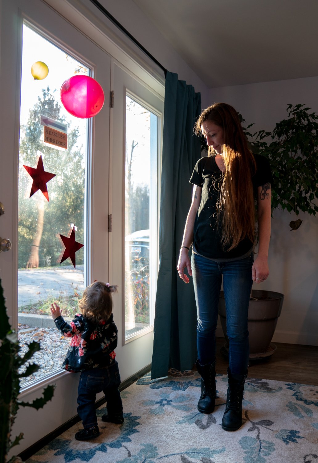 Amanda Kennedy, 32, looks down at her daughter Lily Gillespie, 1, during a visitation on Nov. 3, 2021 at Serenity Grove in Athens, Ohio. Kennedy is a resident at Serenity Grove, a Level 2 transitional recovery house for women recovering from substan