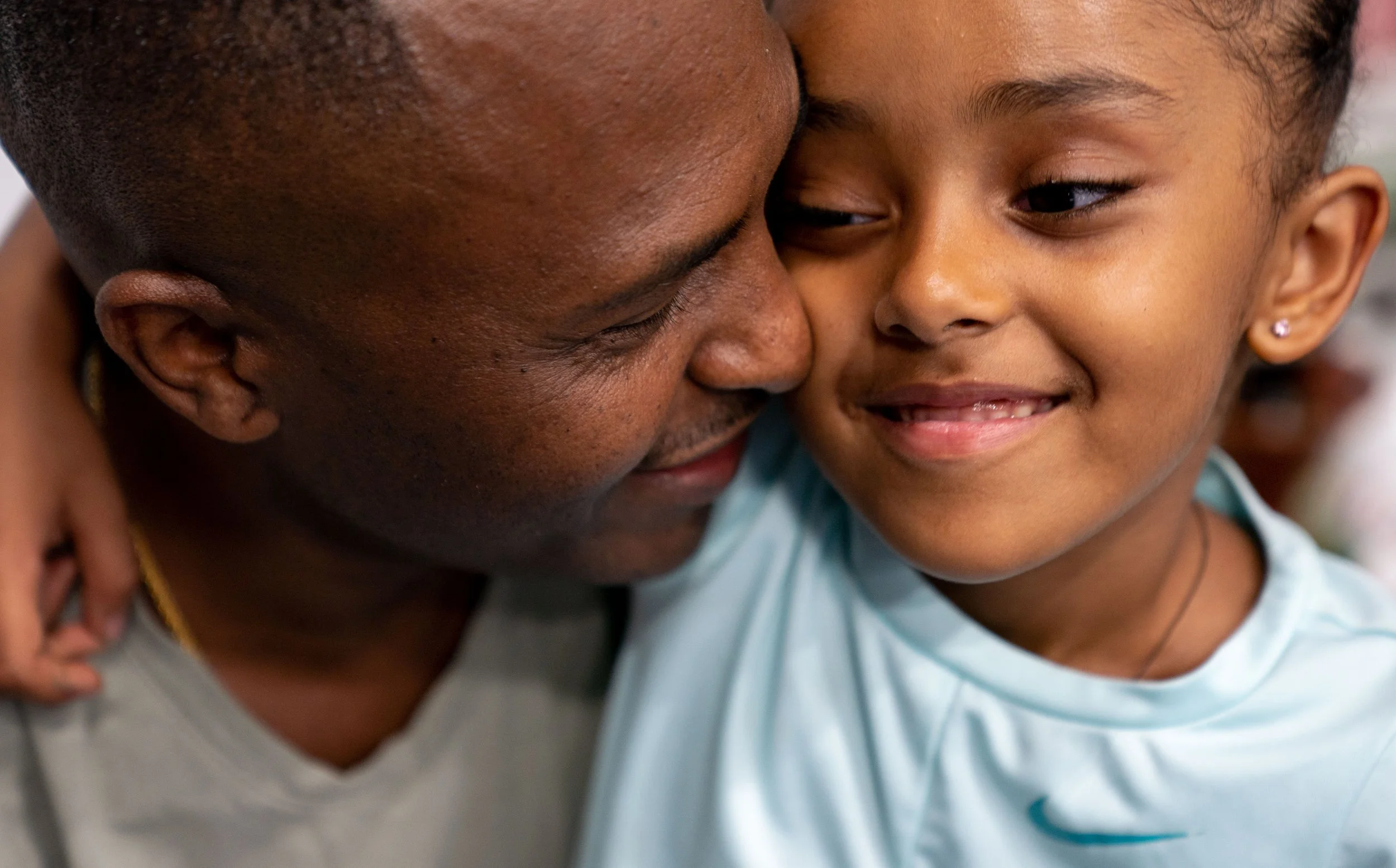  Teddy Tadessae, 46, of Woodbury, Minn. embraces his daughter Bella Tedros, 5, during Ethiopian Day Saturday, July 23, 2022 at the Gangelhoff Center at Concordia University Stadium in St. Paul, Minn.    
