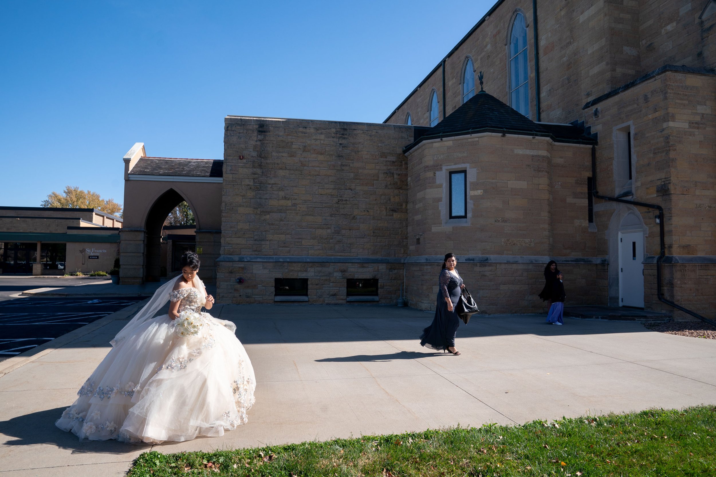  Camila Avilez, 15, walks outside of St. Francis of Assisi Catholic Church for her quinceañera service Oct. 15, 2022 in Rochester, Minn. A quinceañera, which has cultural roots in Mexico, is often both a religious and social ceremony celebrating a gi