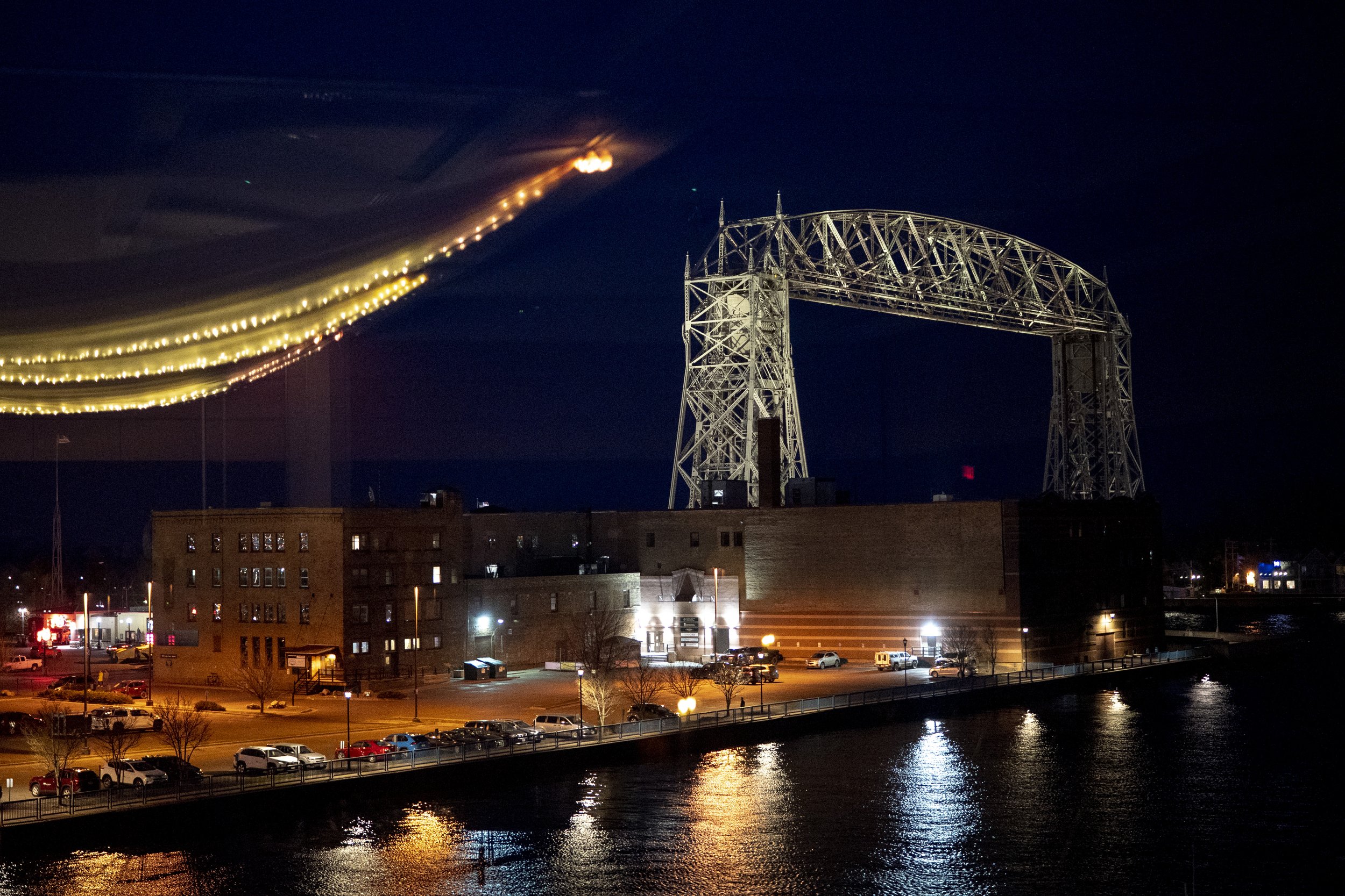  A reflection of prom light decorations is cast in a window overlooking the Aerial Lift Bridge in Duluth, Minn.  