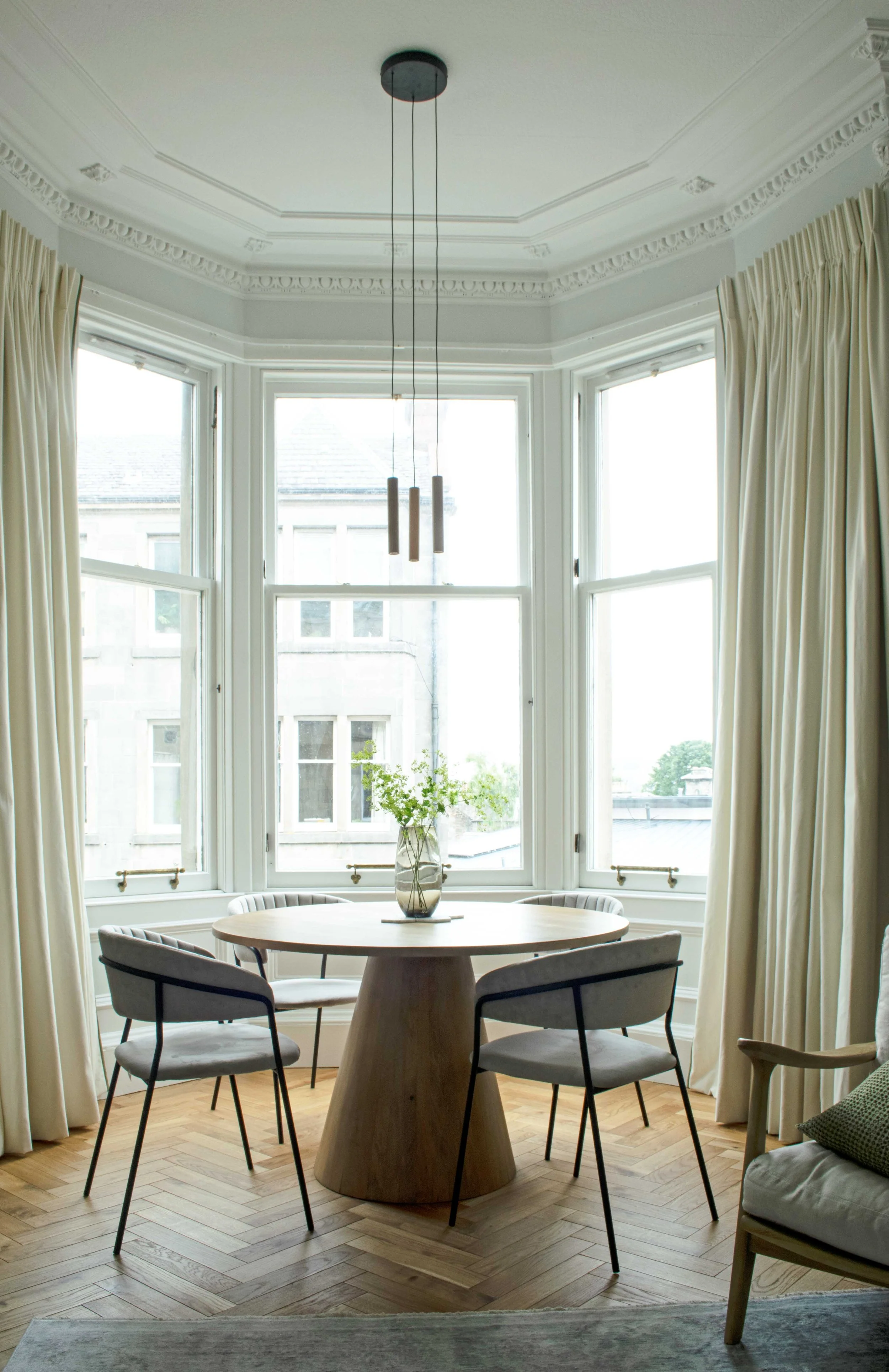 Scandinavian dining area in living room window bay of an Edinburgh flat