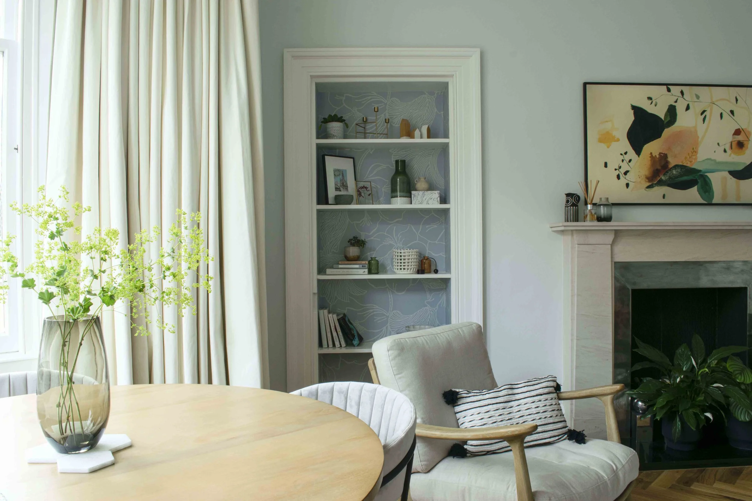 Living room shallow storage transformed into a shelving unit niche with handmade wallpaper ©Detail Movement Interiors
