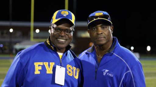 fvsu fans in blue and gold fan gear at a football game with sunglasses on