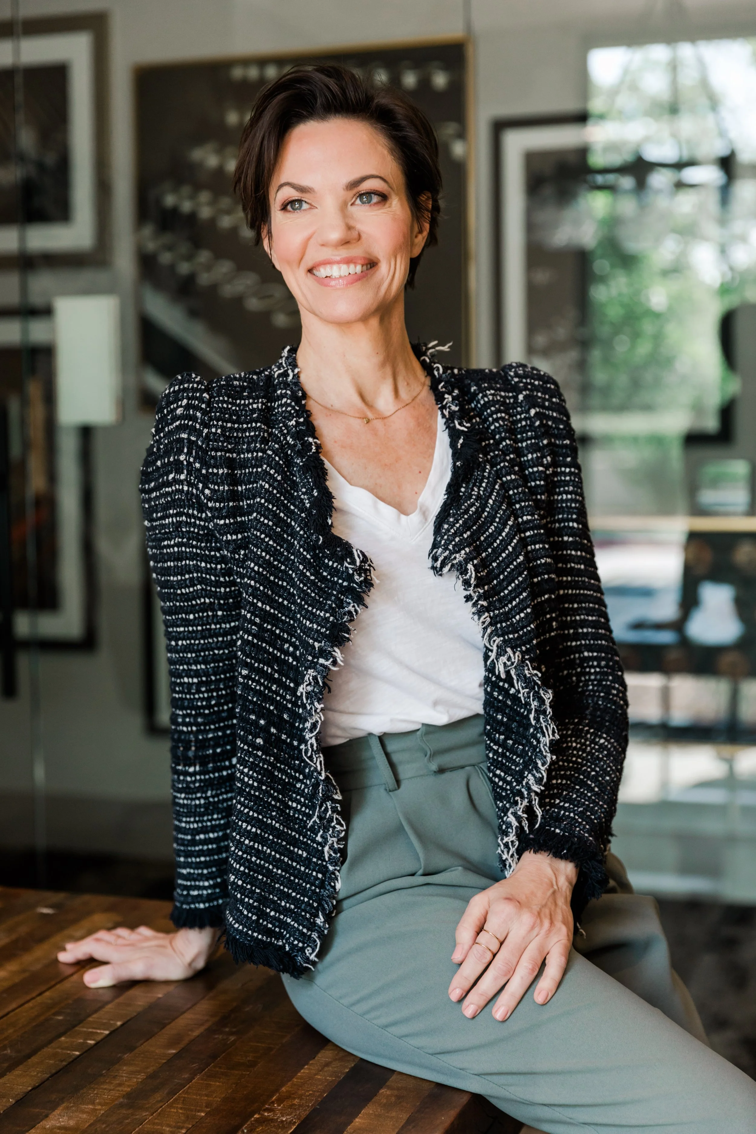 Heather Rees - woman leaning on a desk and smiling