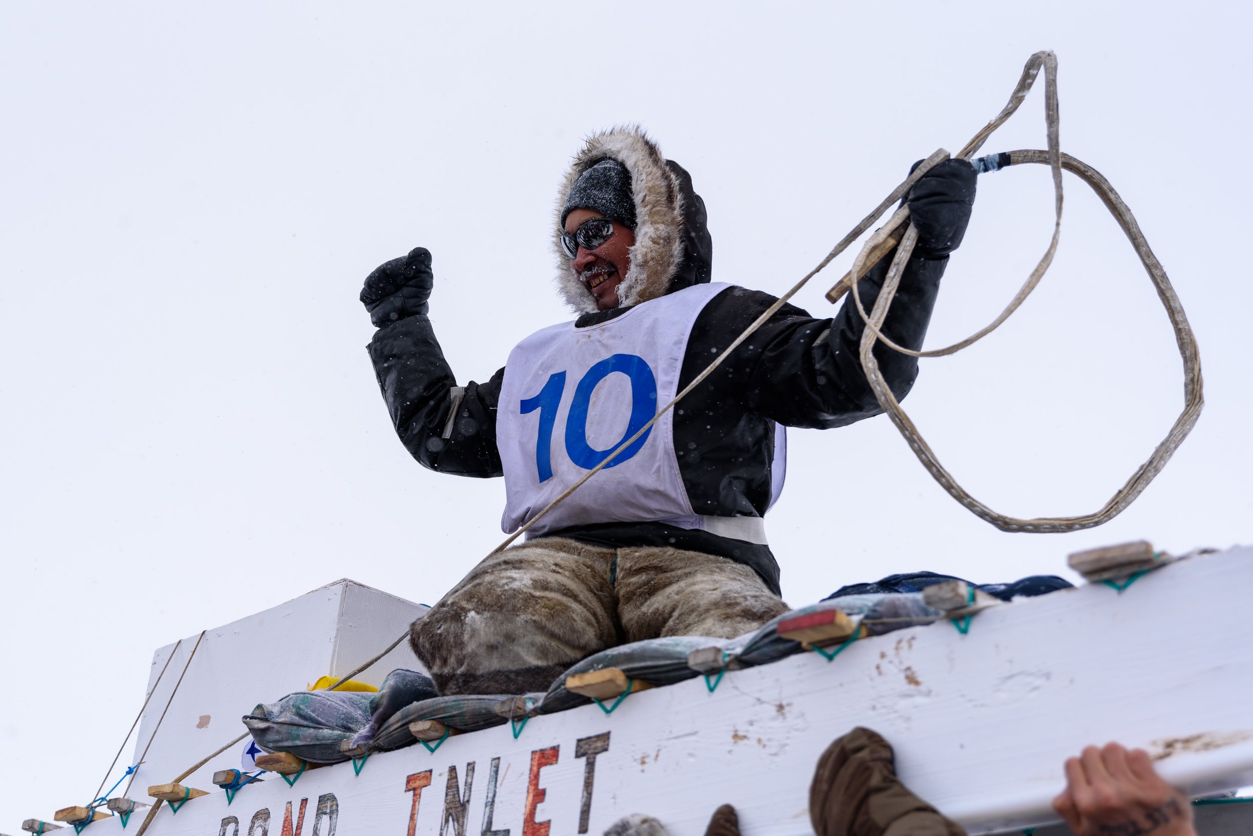  Lee Inuarak, of Pond Inlet, is hoisted into the air after being first to cross the finish line of the NunavutQuest in Igloolik, Nunavut on Wednesday, April 27, 2022. The winner of the quest will be announced during an award ceremony on April 28. Sho