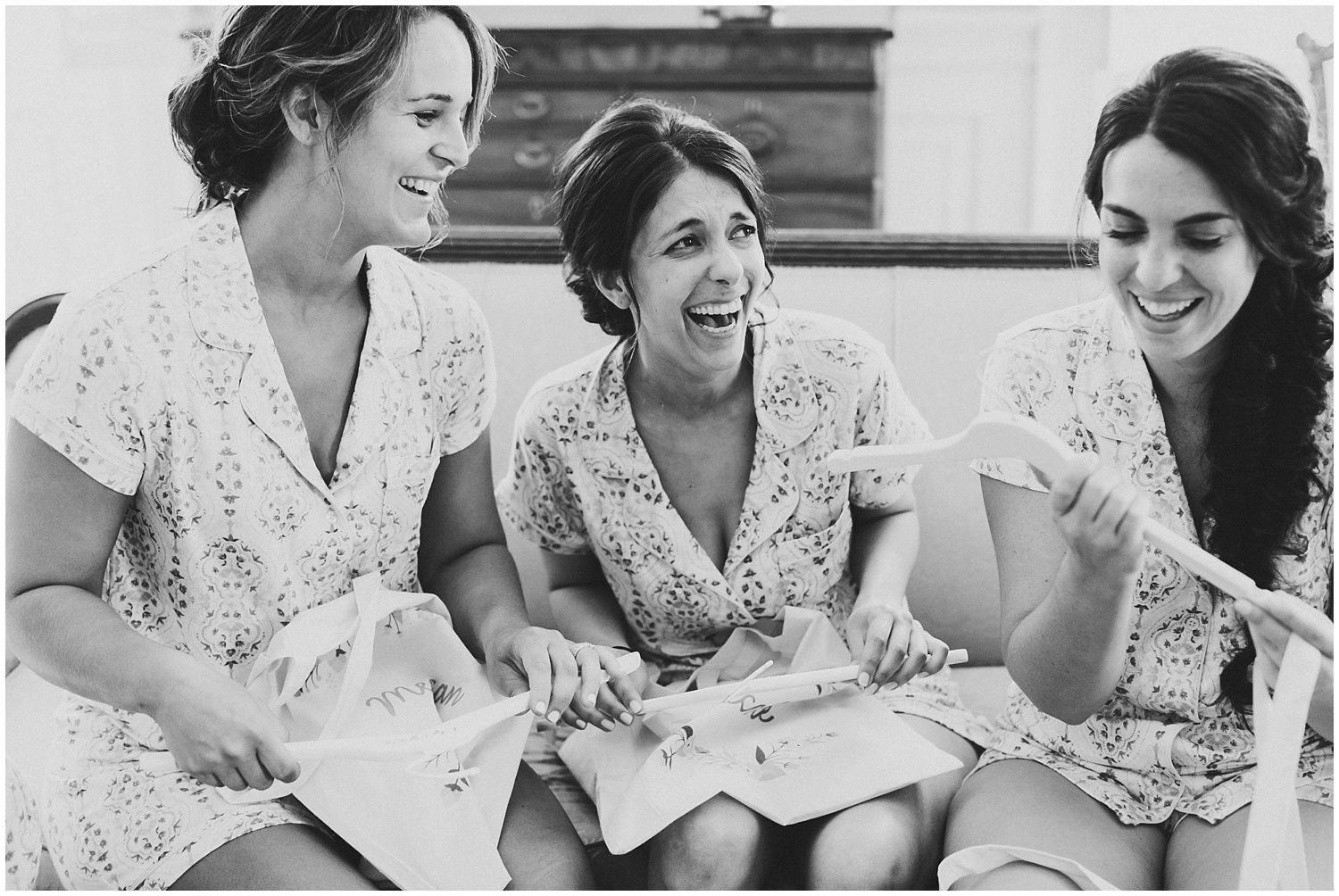 bridesmaids laughing in matching robes