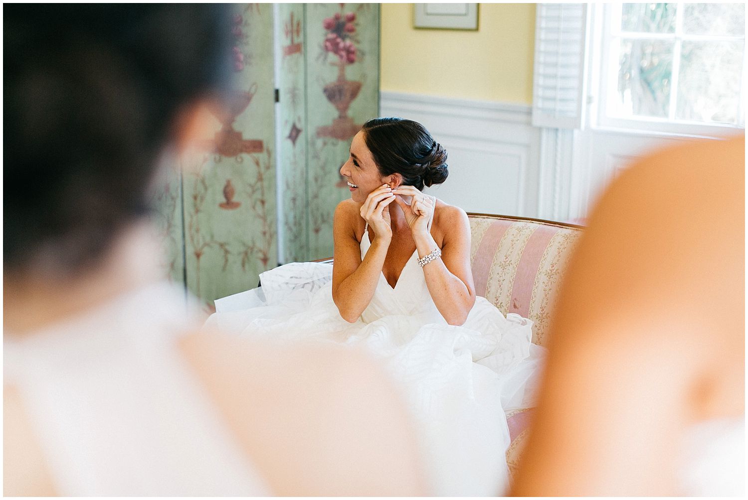 bride putting in earrings