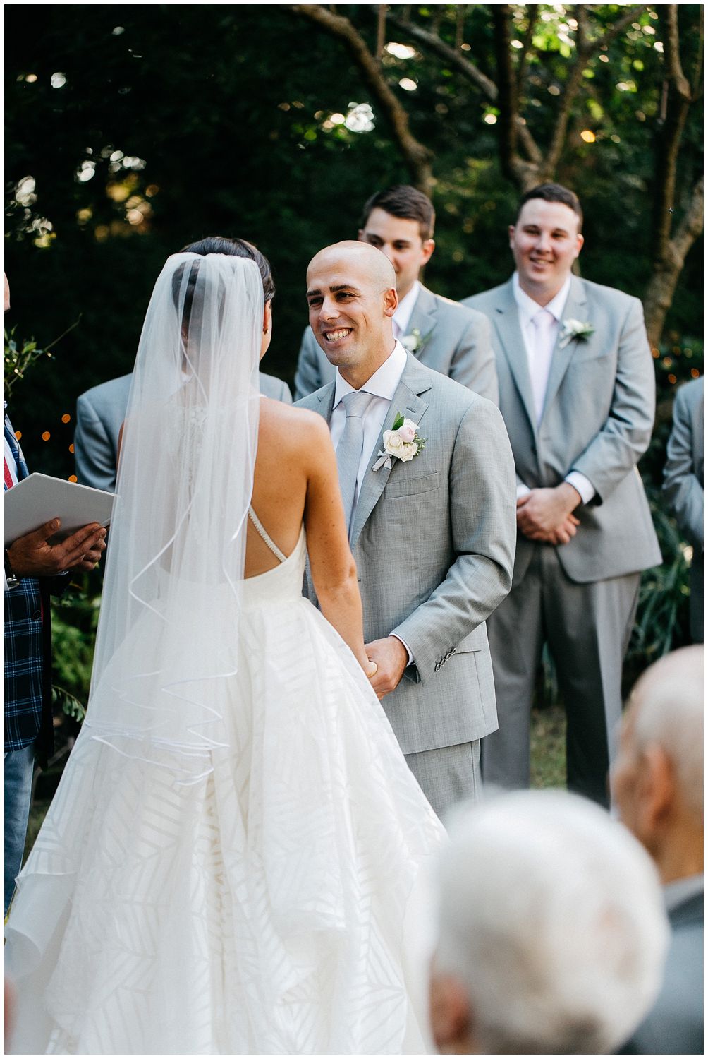 happy groom exchanging vows