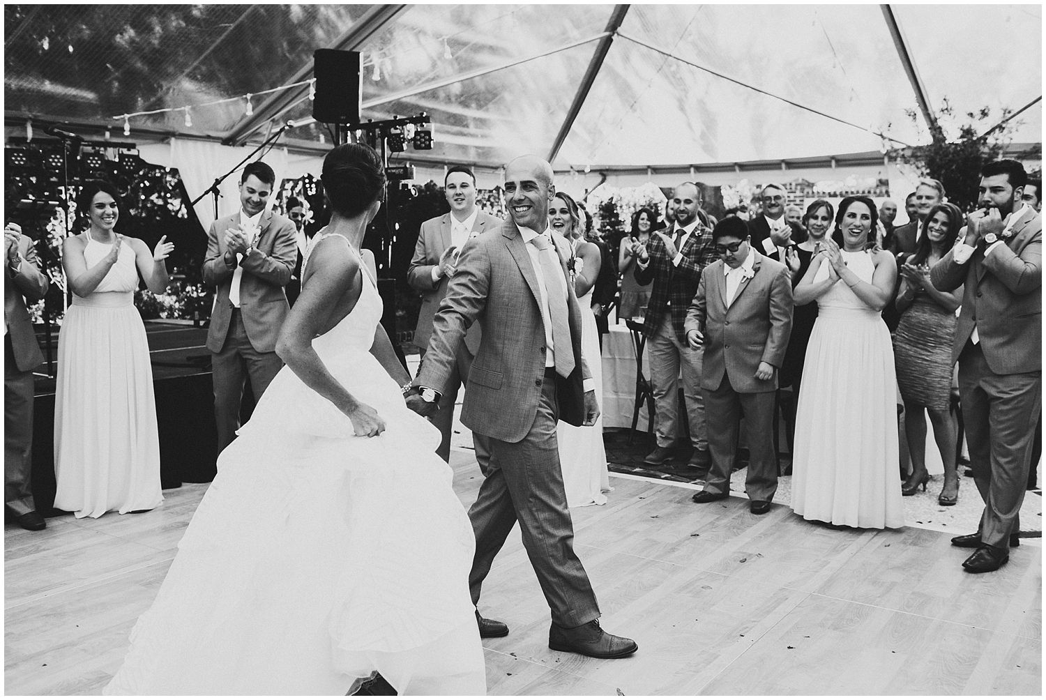 bride and groom on dance floor with clear top tent