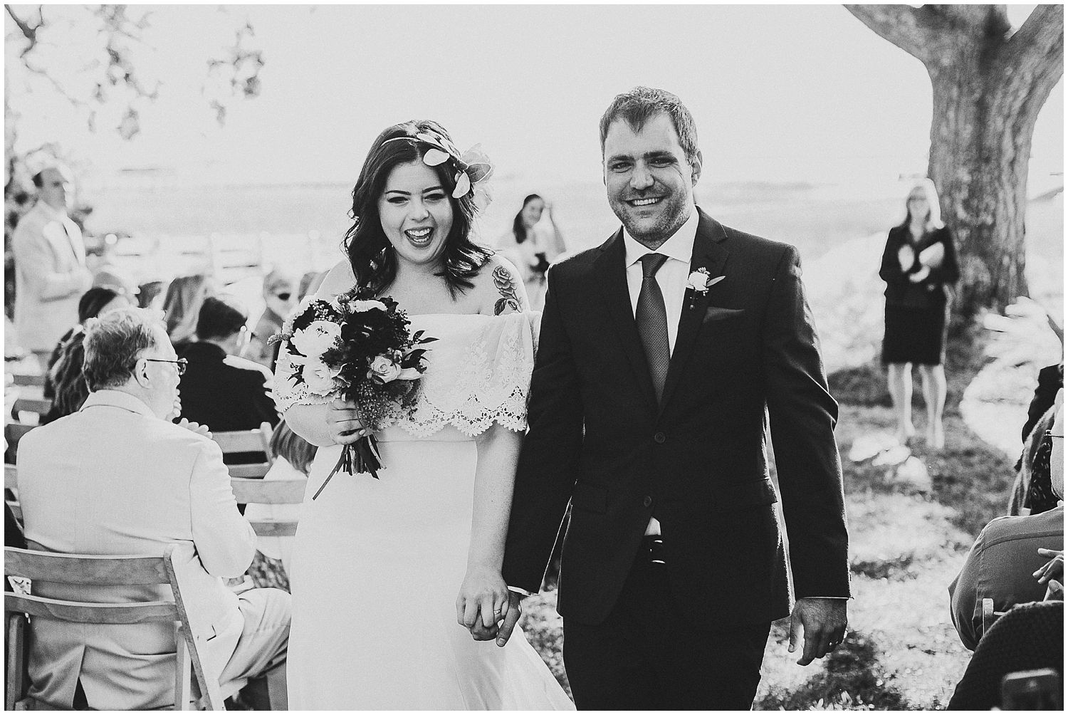 black and white couple recessing down aisle