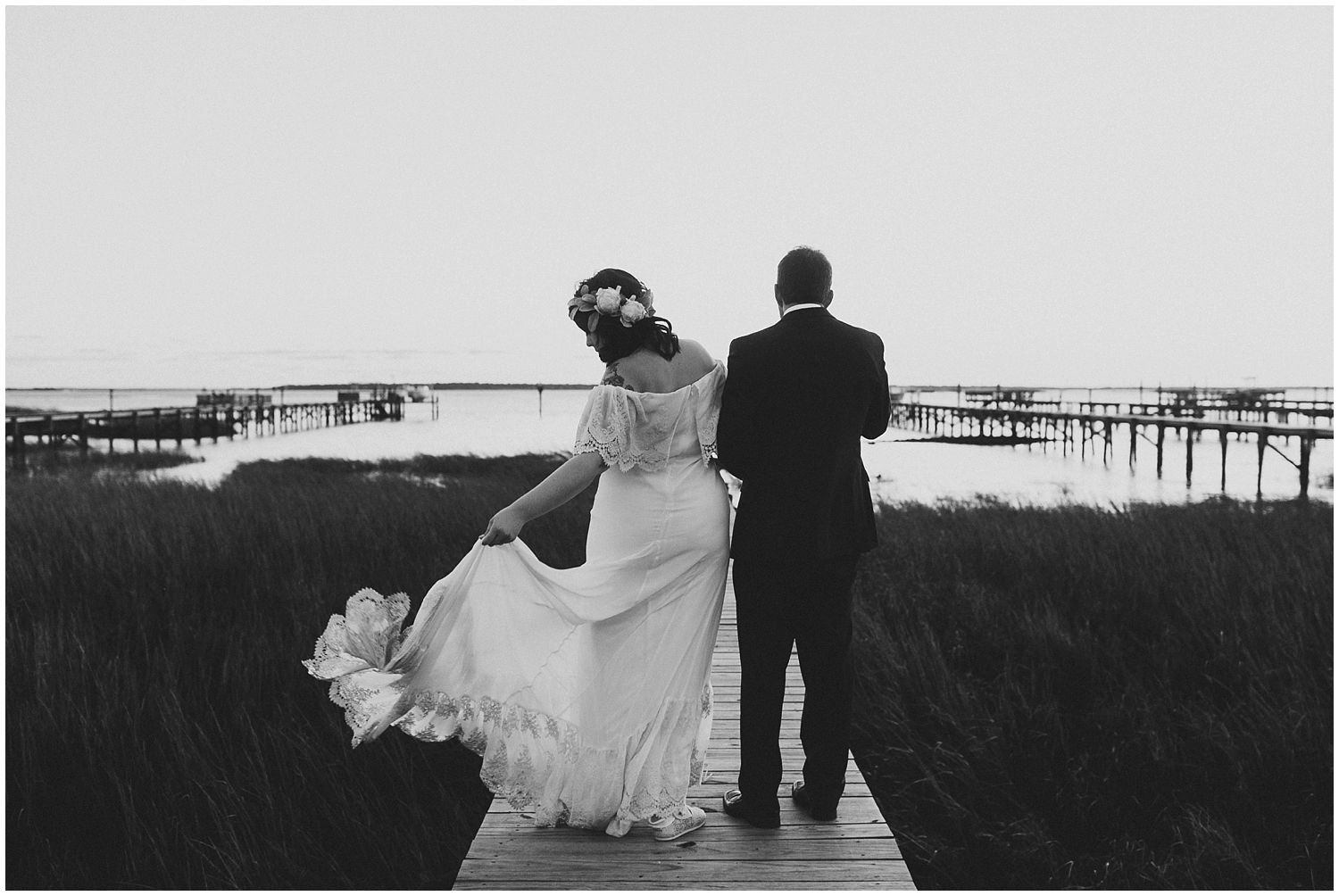 bride and groom on dock on marsh