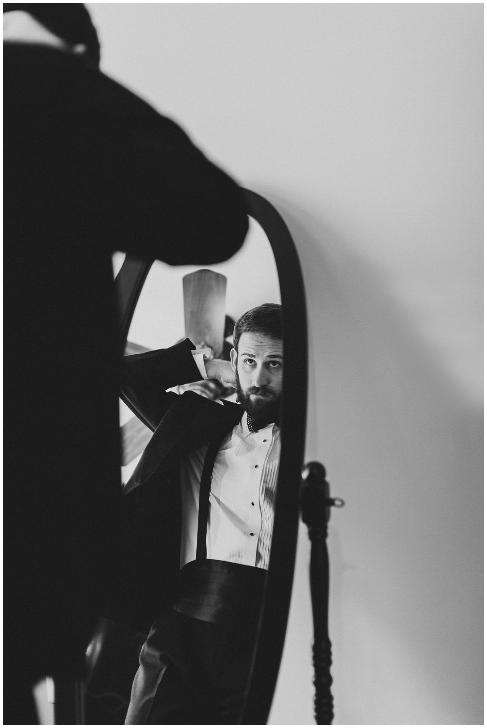 groom getting ready in front of mirror