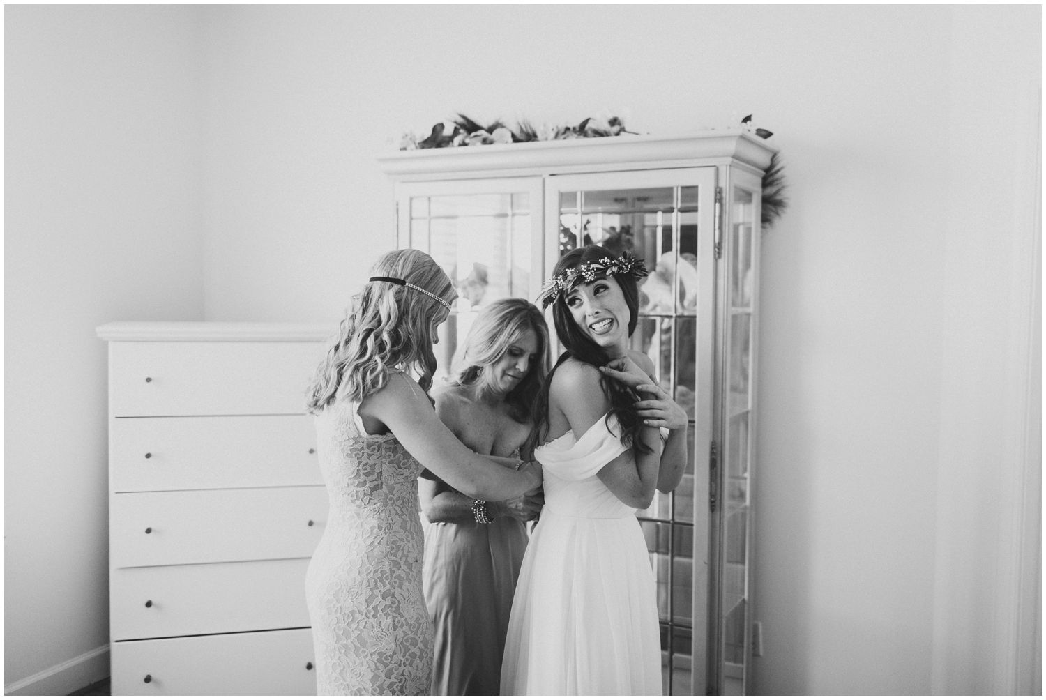 bride getting dressed with friends