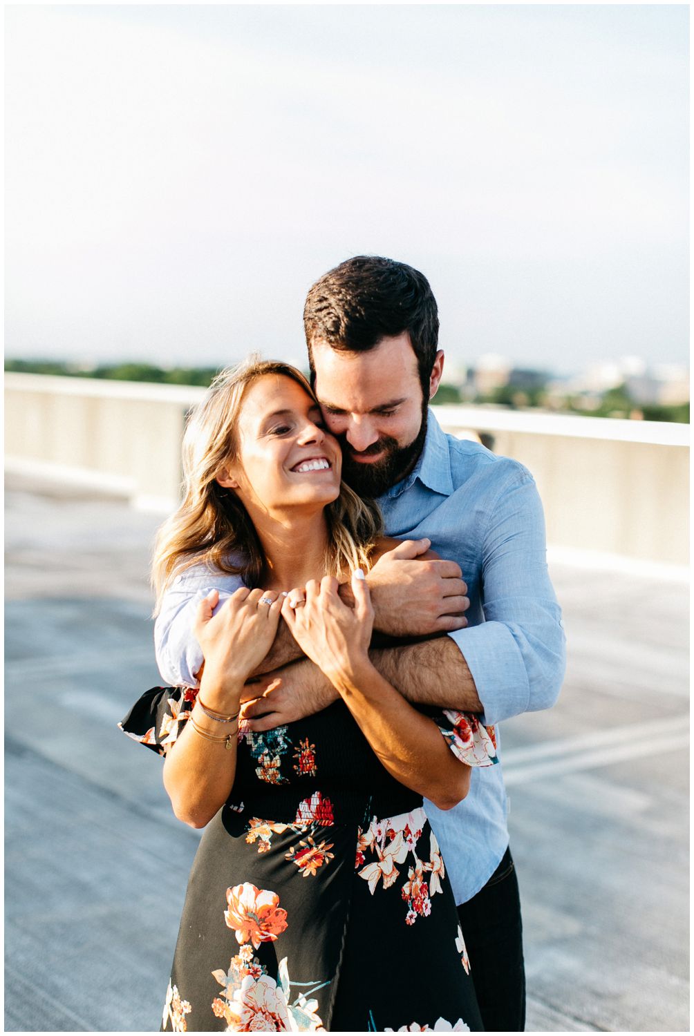 Laughing rooftop engagement session