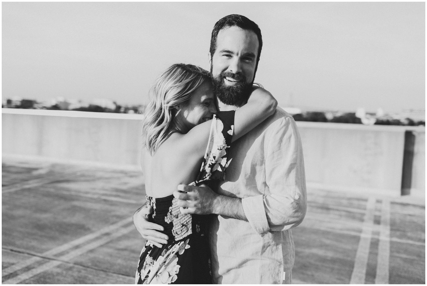 Playful couple on rooftop engagement session