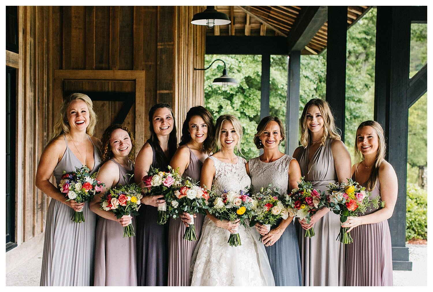 Bridesmaids in mismatched neutral dresses