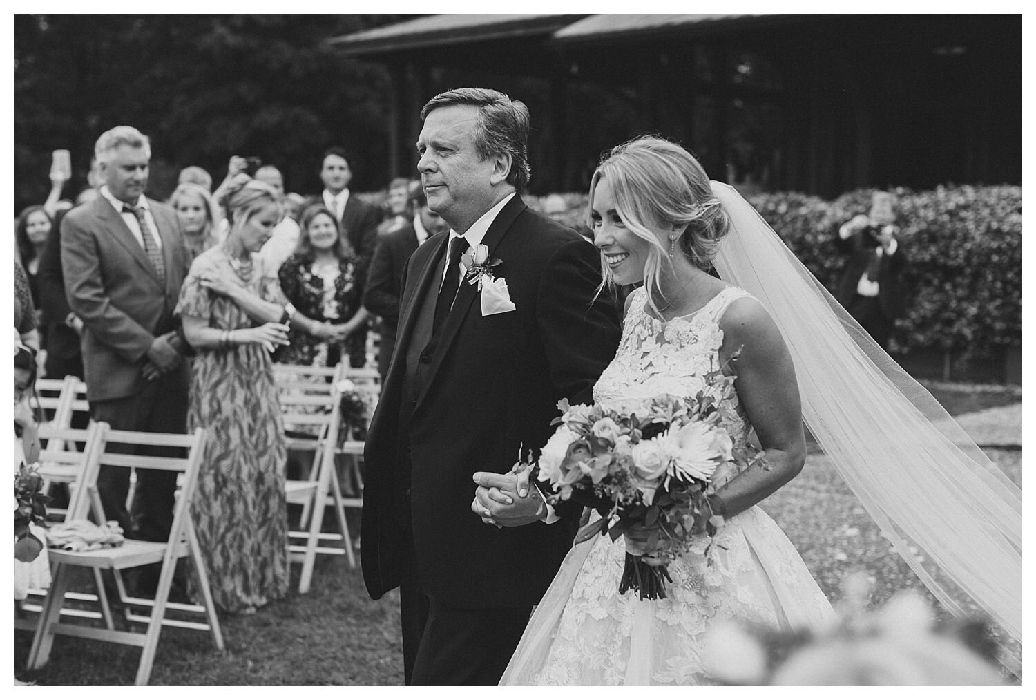 bride walking down aisle with father