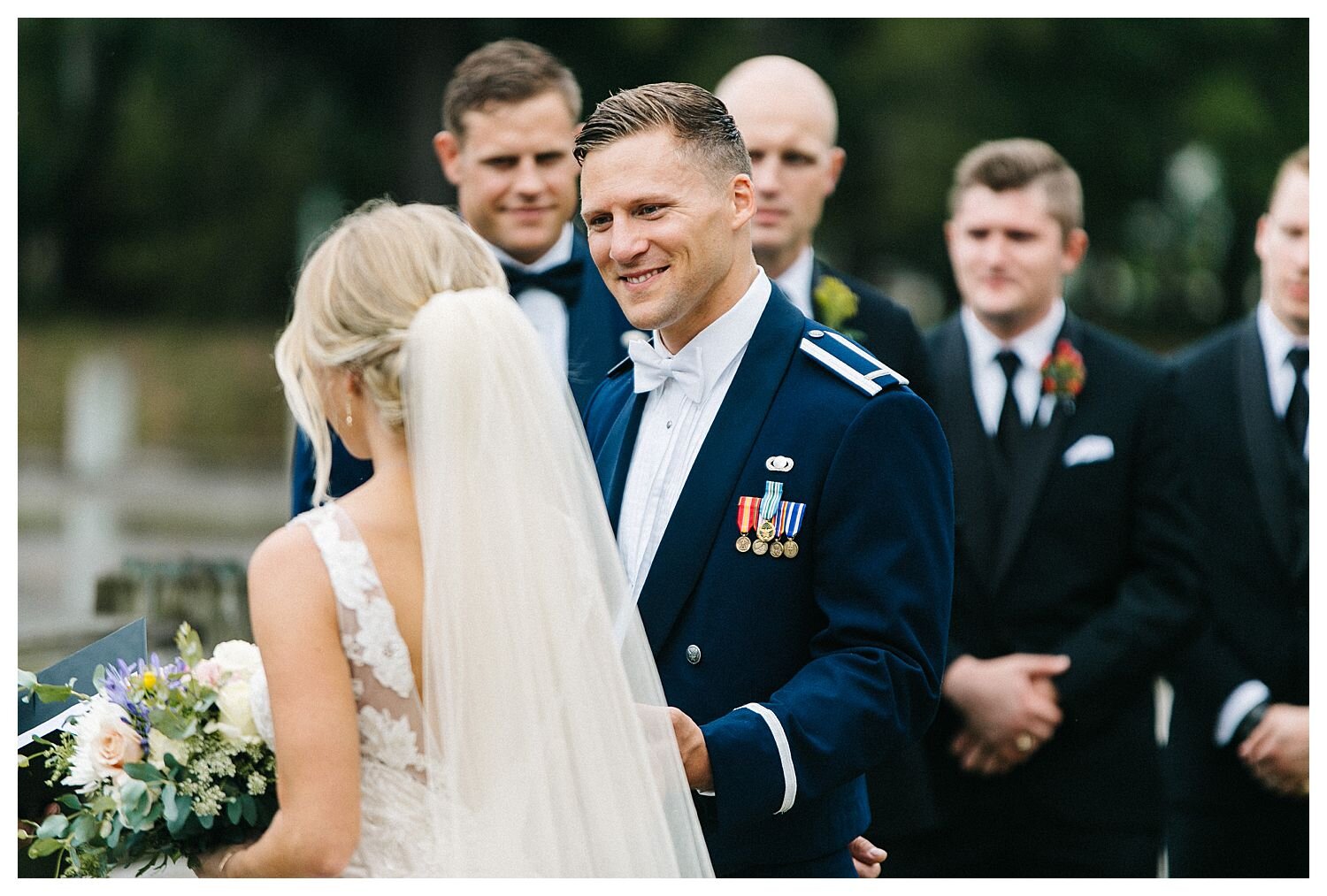 groom looks lovingly at bride