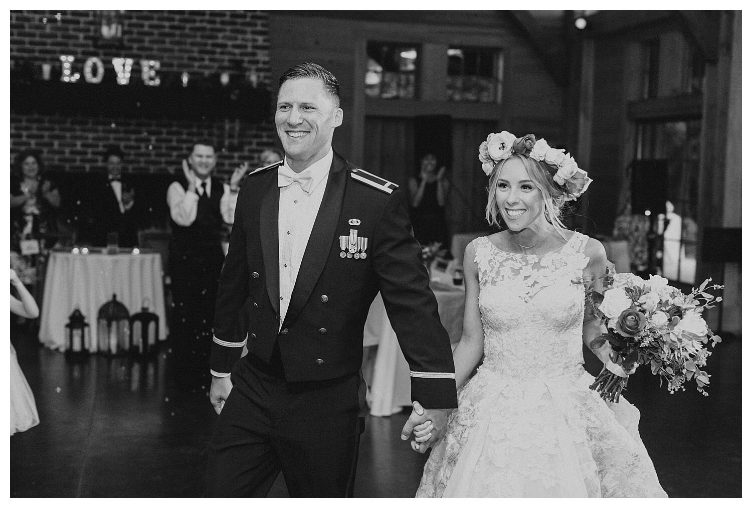 black and white bride and groom entering reception