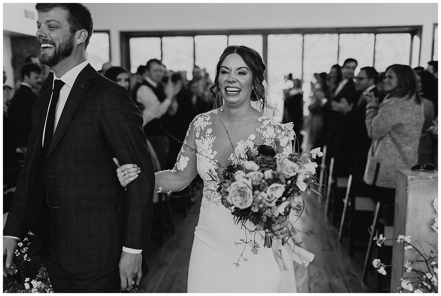 joyful bride and groom walking down aisle