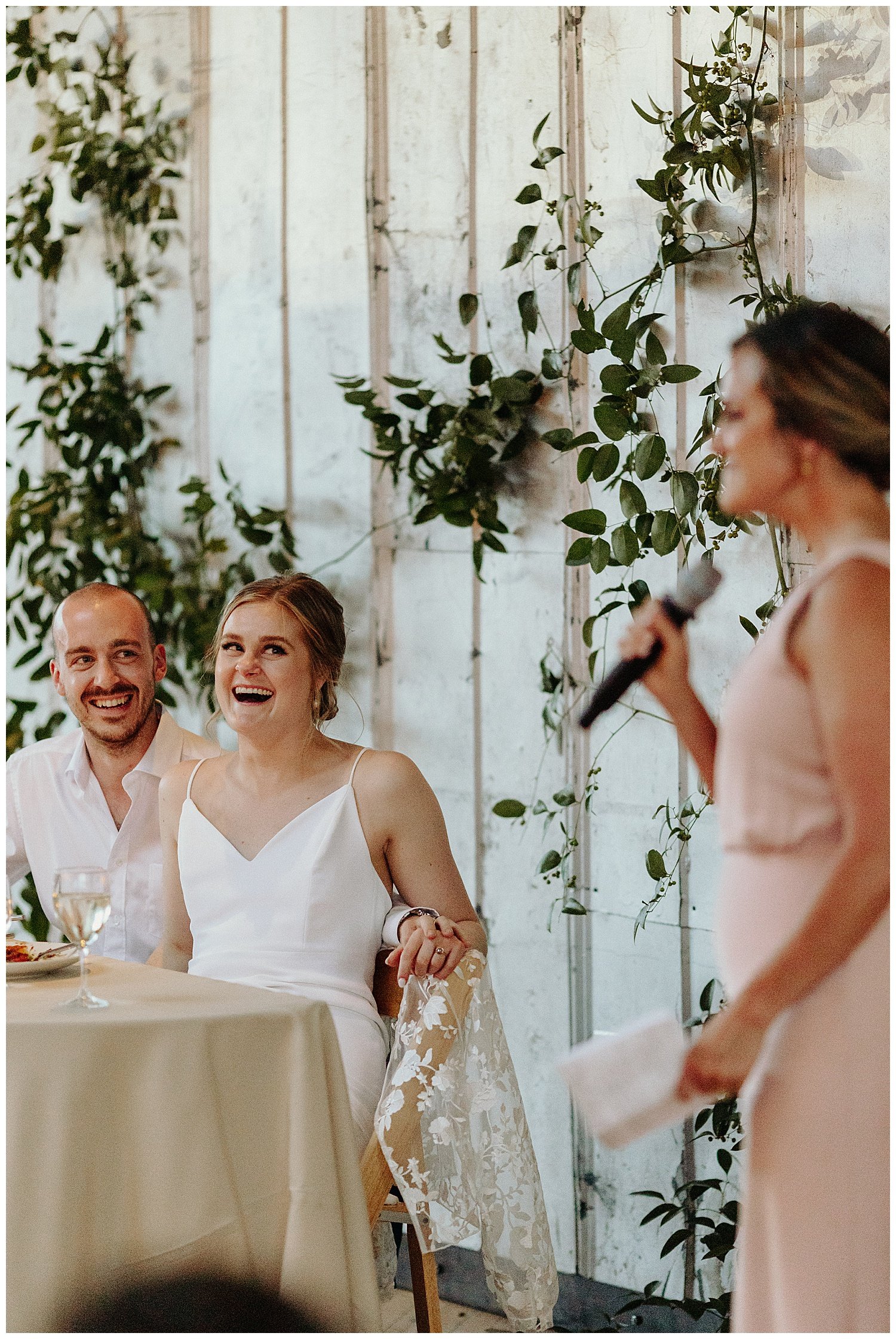 couple laughing during wedding speech
