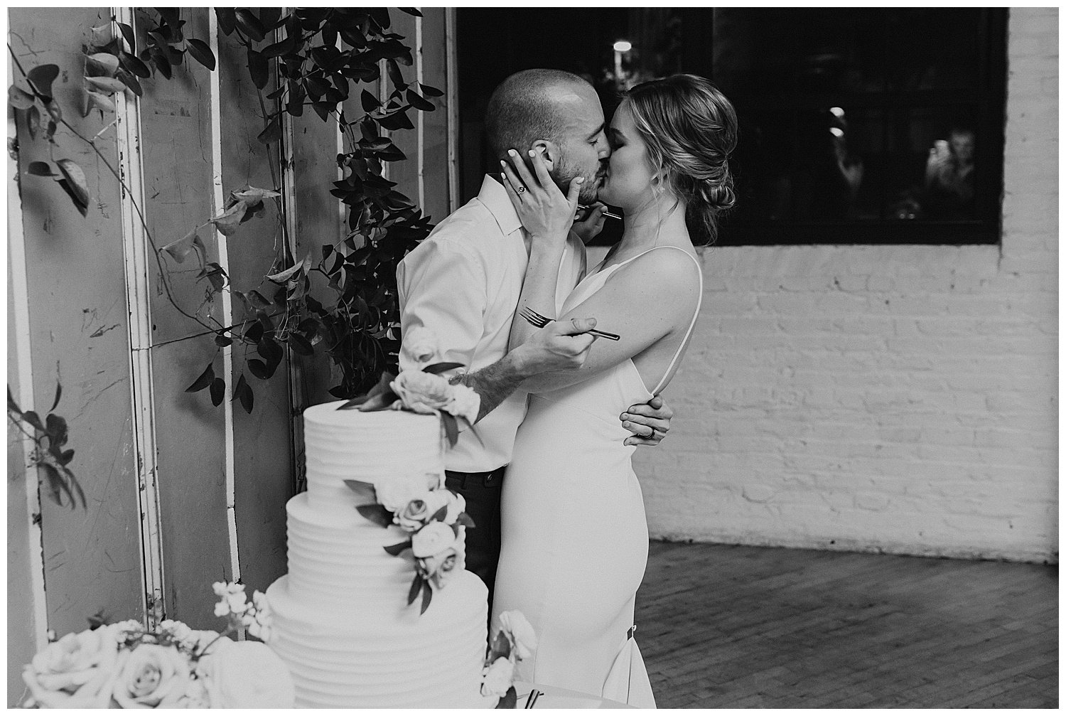 wedding cake cutting in black and white