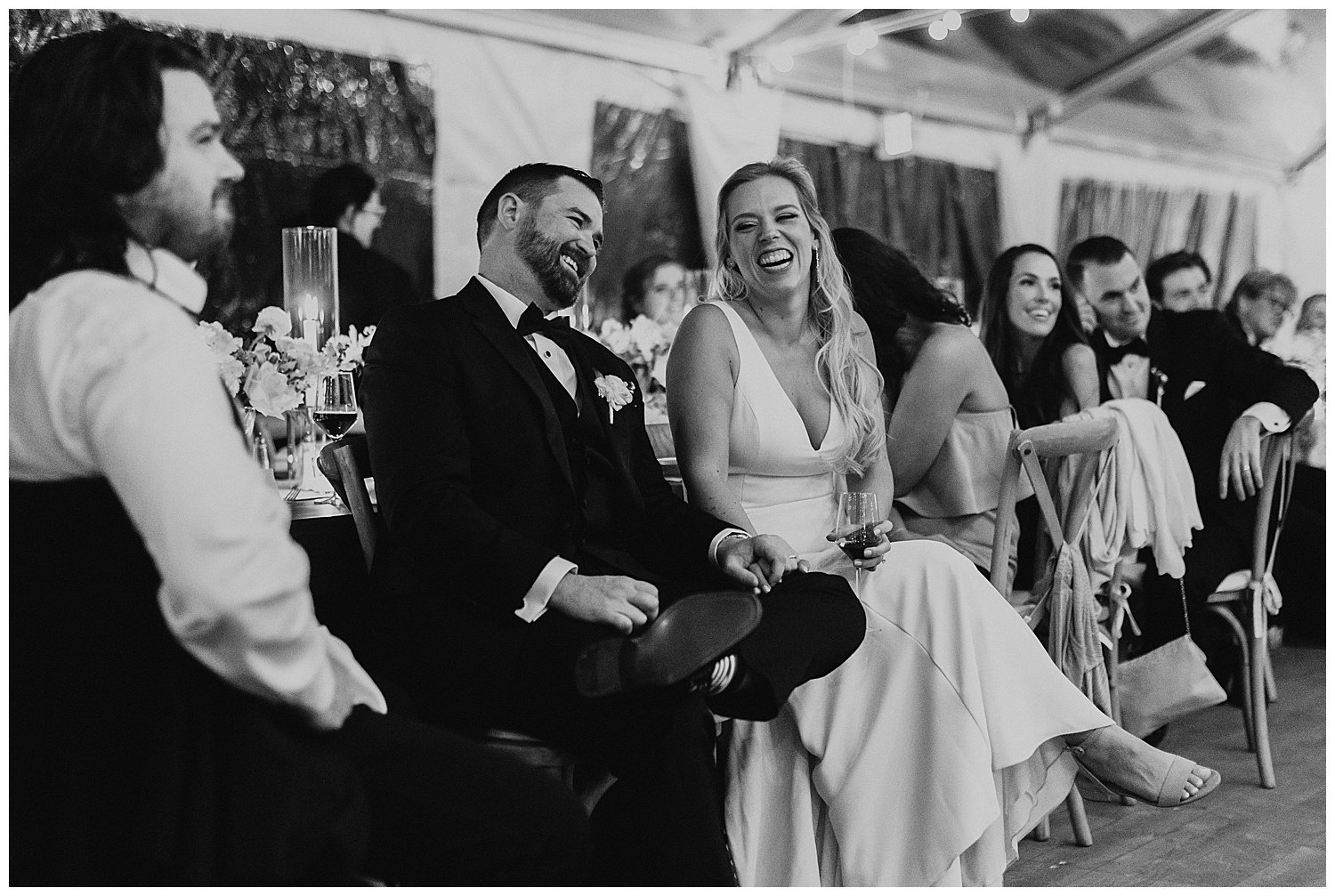 couple laughing during wedding speeches