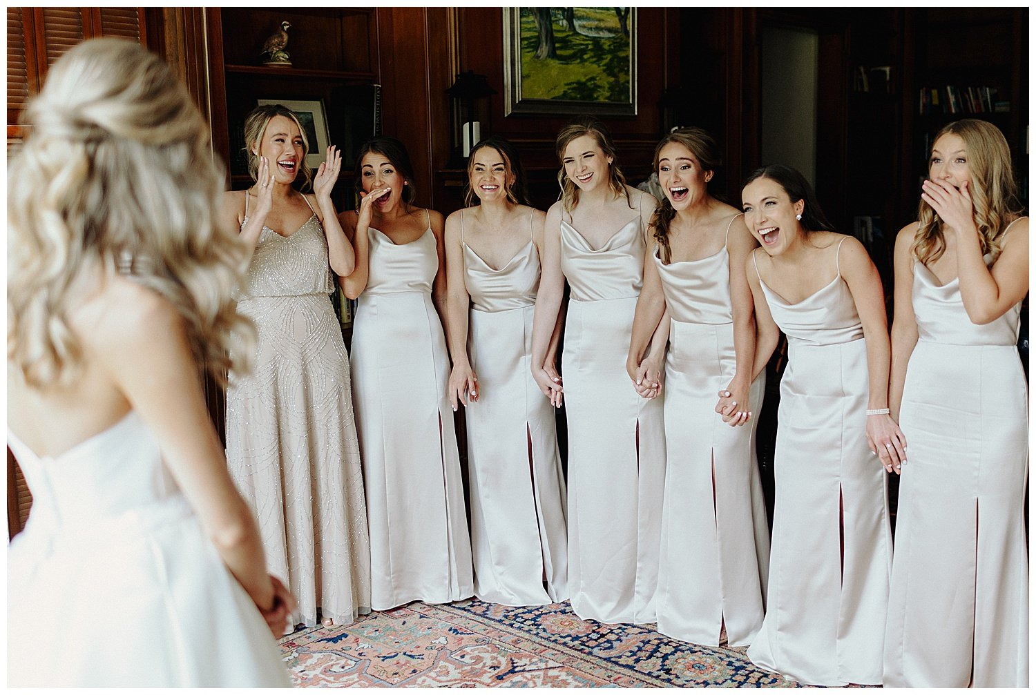 bride having reveal with bridesmaids