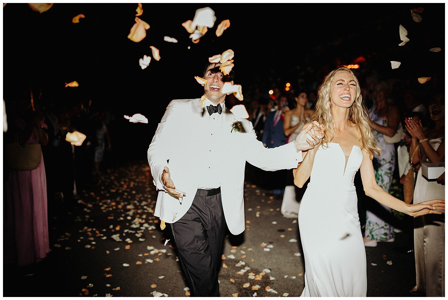 bride and groom exit with flower petal toss