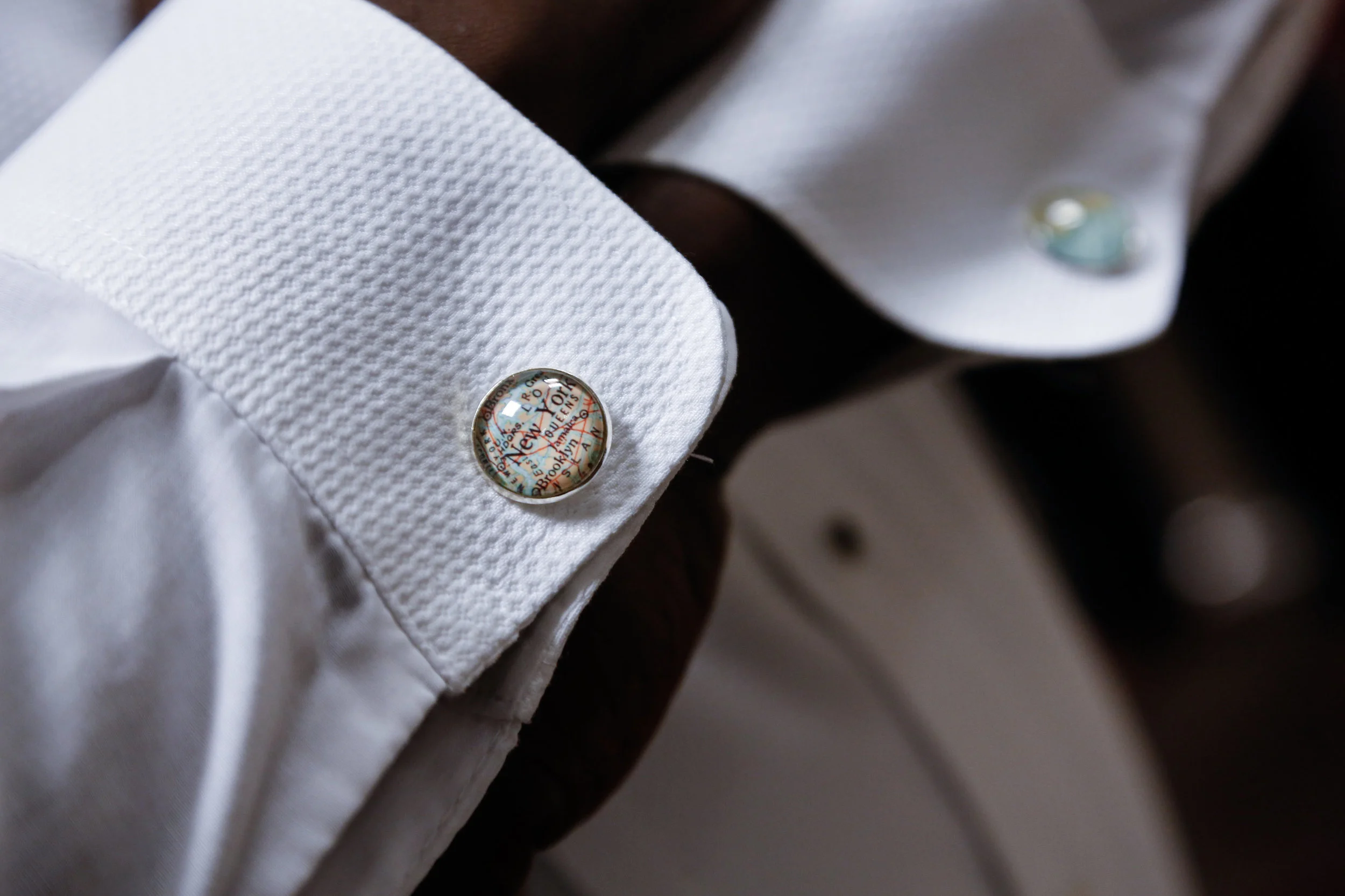 Groomsmen received custom cufflinks with the city they live in and the location their familes descended from. Antoine wore New york and Barbados at the wedding.